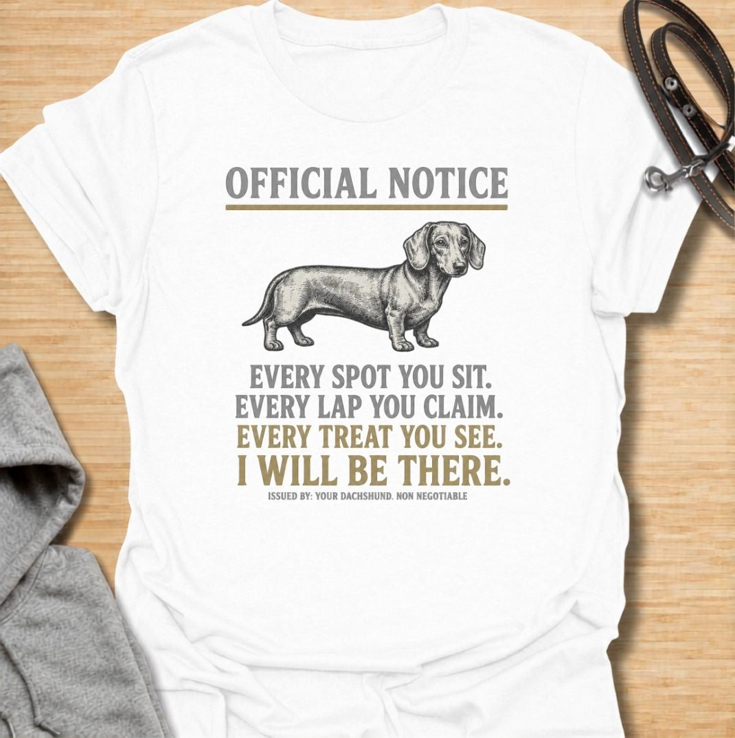 A funny dachshund T-shirt for anyone who knows personal space stops existing once a dachshund moves in. Featuring the phrase “Every Spot You Sit. Every Lap You Claim. Every Treat You See. I Will Be There,” this design captures the breed’s clingy, food-focused personality with dry humor. Perfect for dachshund moms, dachshund dads, sausage dog owners, and anyone living with a devoted little shadow. A playful everyday tee for fans of dachshund humor, velcro dogs, and breed-specific dog gifts.