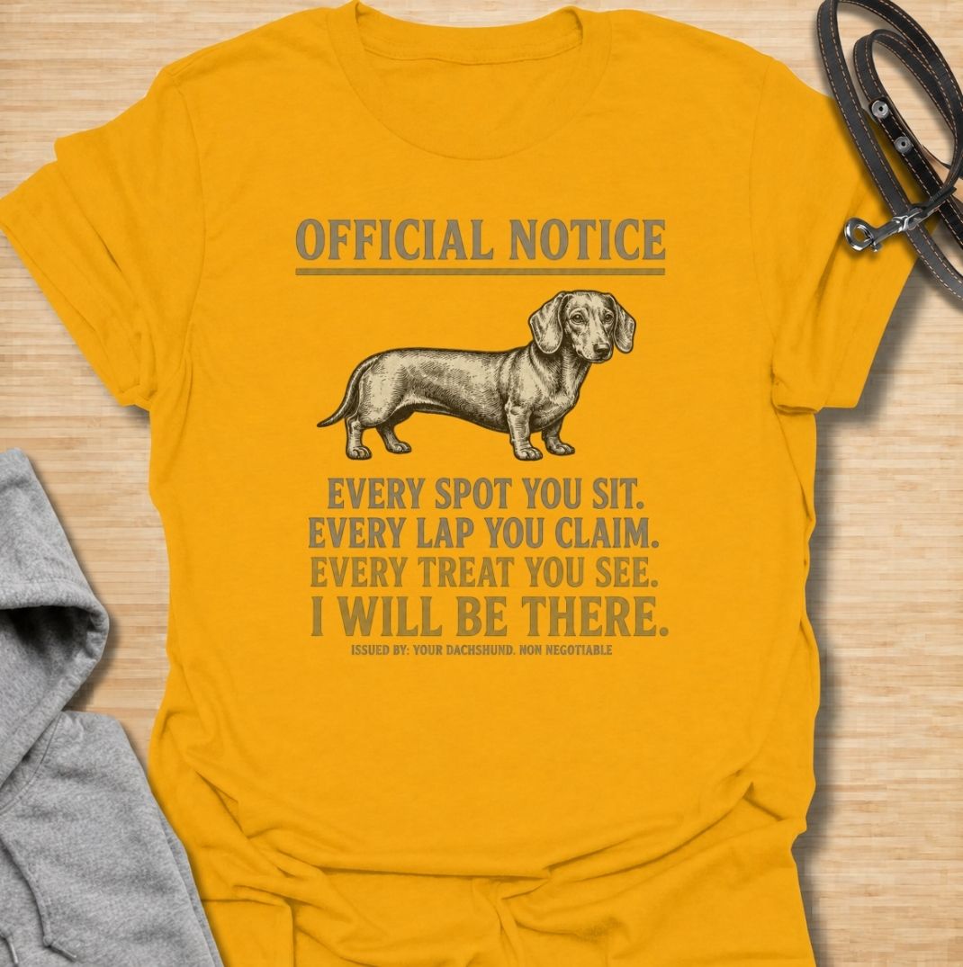A funny dachshund T-shirt for anyone who knows personal space stops existing once a dachshund moves in. Featuring the phrase “Every Spot You Sit. Every Lap You Claim. Every Treat You See. I Will Be There,” this design captures the breed’s clingy, food-focused personality with dry humor. Perfect for dachshund moms, dachshund dads, sausage dog owners, and anyone living with a devoted little shadow. A playful everyday tee for fans of dachshund humor, velcro dogs, and breed-specific dog gifts.