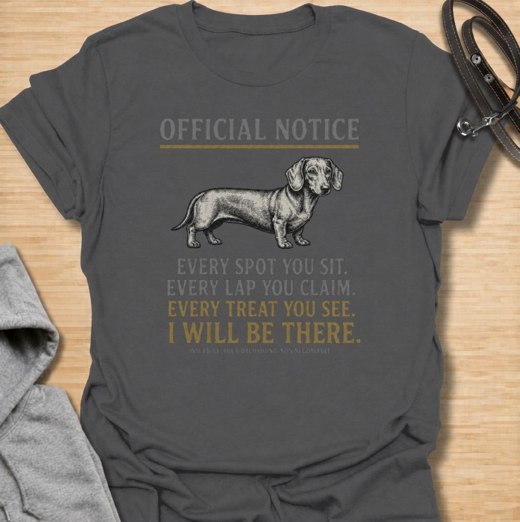 A funny dachshund T-shirt for anyone who knows personal space stops existing once a dachshund moves in. Featuring the phrase “Every Spot You Sit. Every Lap You Claim. Every Treat You See. I Will Be There,” this design captures the breed’s clingy, food-focused personality with dry humor. Perfect for dachshund moms, dachshund dads, sausage dog owners, and anyone living with a devoted little shadow. A playful everyday tee for fans of dachshund humor, velcro dogs, and breed-specific dog gifts.