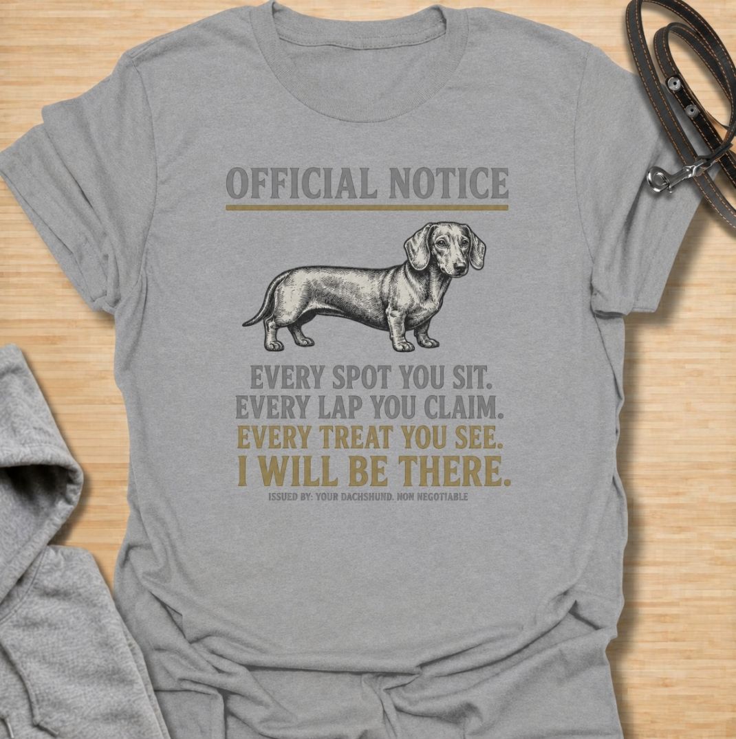 A funny dachshund T-shirt for anyone who knows personal space stops existing once a dachshund moves in. Featuring the phrase “Every Spot You Sit. Every Lap You Claim. Every Treat You See. I Will Be There,” this design captures the breed’s clingy, food-focused personality with dry humor. Perfect for dachshund moms, dachshund dads, sausage dog owners, and anyone living with a devoted little shadow. A playful everyday tee for fans of dachshund humor, velcro dogs, and breed-specific dog gifts.