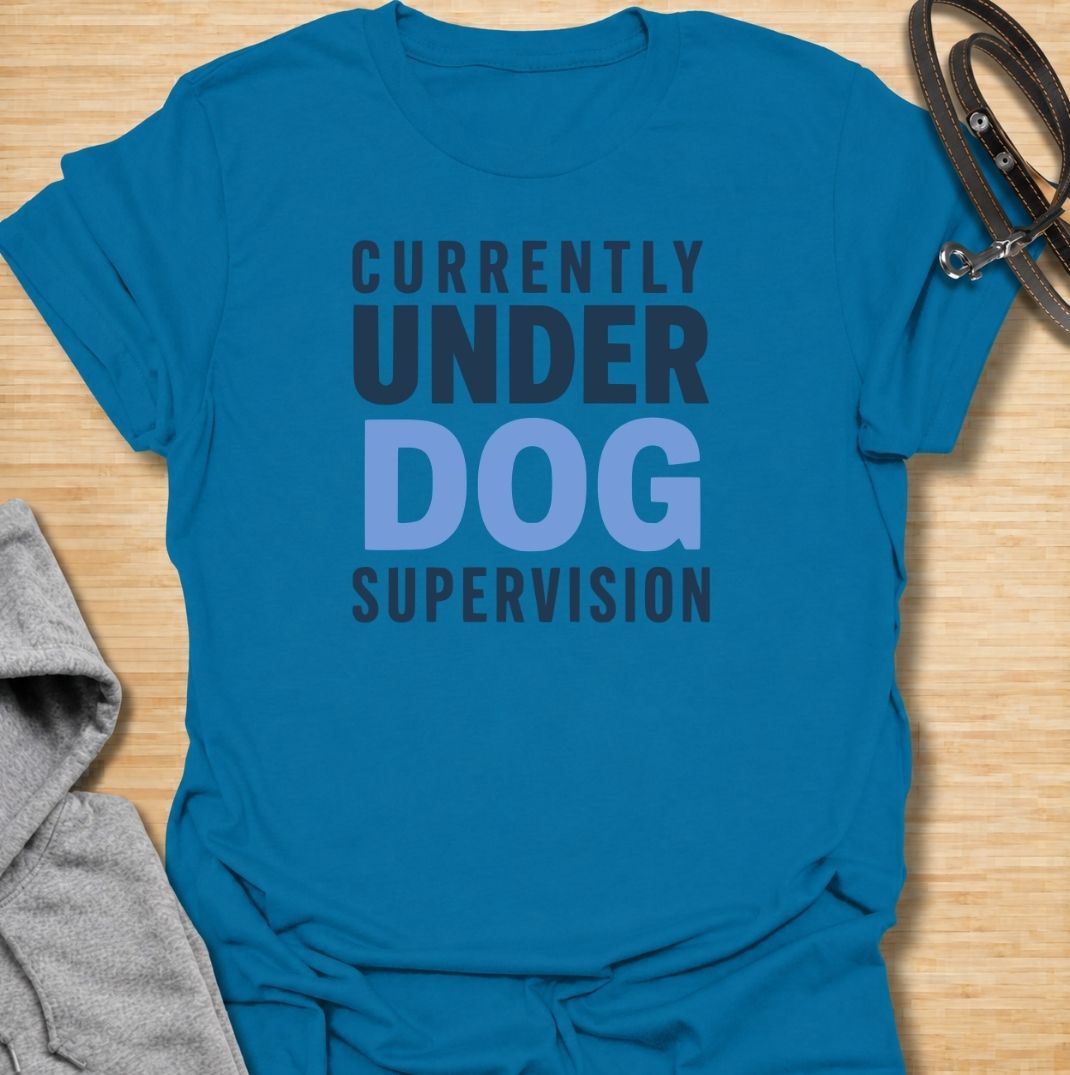 A funny dog T-shirt for anyone who knows their four-legged supervisor is always watching. Featuring the phrase “Currently Under Dog Supervision,” this clean text-based design is perfect for dog owners whose pets like to keep a close eye on everything they do. Ideal for dog moms, dog dads, rescue dog owners, and anyone who lives life under constant canine observation. A simple everyday tee for fans of funny dog sayings, dog lover humor, and general dog gifts.
