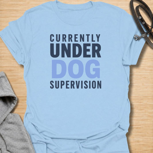 A funny dog T-shirt for anyone who knows their four-legged supervisor is always watching. Featuring the phrase “Currently Under Dog Supervision,” this clean text-based design is perfect for dog owners whose pets like to keep a close eye on everything they do. Ideal for dog moms, dog dads, rescue dog owners, and anyone who lives life under constant canine observation. A simple everyday tee for fans of funny dog sayings, dog lover humor, and general dog gifts.
