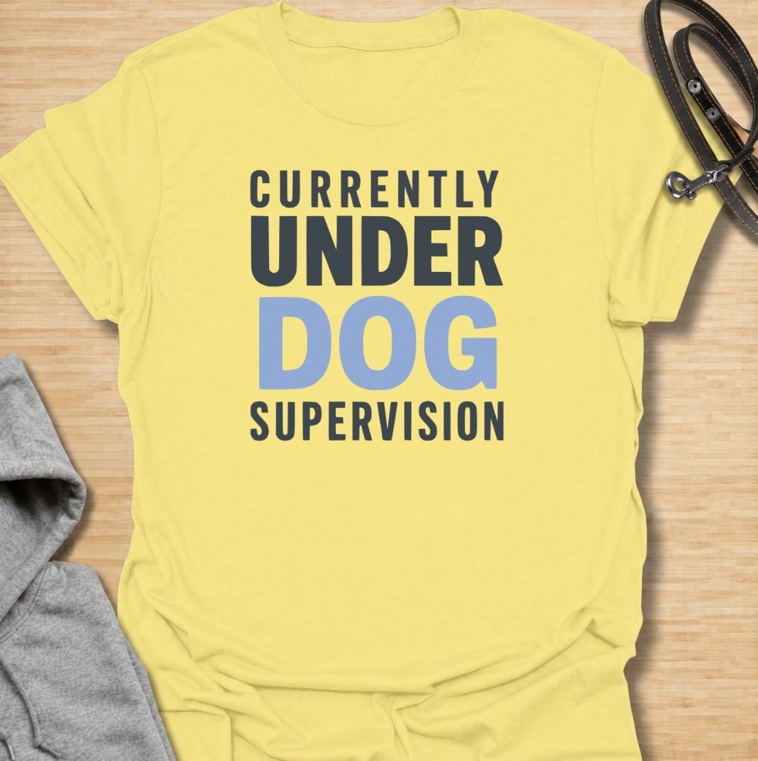A funny dog T-shirt for anyone who knows their four-legged supervisor is always watching. Featuring the phrase “Currently Under Dog Supervision,” this clean text-based design is perfect for dog owners whose pets like to keep a close eye on everything they do. Ideal for dog moms, dog dads, rescue dog owners, and anyone who lives life under constant canine observation. A simple everyday tee for fans of funny dog sayings, dog lover humor, and general dog gifts.