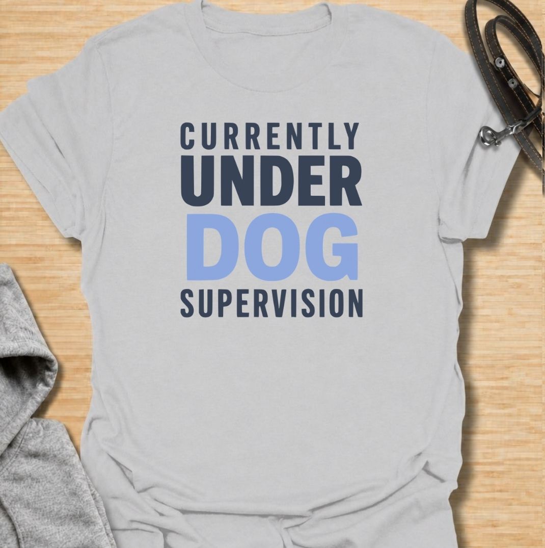 A funny dog T-shirt for anyone who knows their four-legged supervisor is always watching. Featuring the phrase “Currently Under Dog Supervision,” this clean text-based design is perfect for dog owners whose pets like to keep a close eye on everything they do. Ideal for dog moms, dog dads, rescue dog owners, and anyone who lives life under constant canine observation. A simple everyday tee for fans of funny dog sayings, dog lover humor, and general dog gifts.