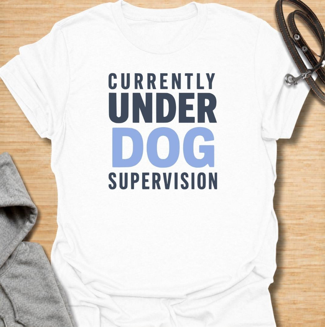 A funny dog T-shirt for anyone who knows their four-legged supervisor is always watching. Featuring the phrase “Currently Under Dog Supervision,” this clean text-based design is perfect for dog owners whose pets like to keep a close eye on everything they do. Ideal for dog moms, dog dads, rescue dog owners, and anyone who lives life under constant canine observation. A simple everyday tee for fans of funny dog sayings, dog lover humor, and general dog gifts.