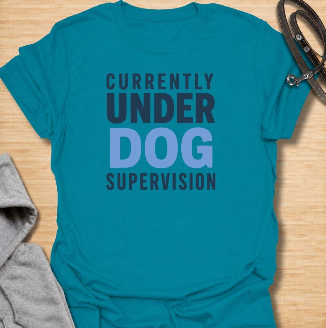 A funny dog T-shirt for anyone who knows their four-legged supervisor is always watching. Featuring the phrase “Currently Under Dog Supervision,” this clean text-based design is perfect for dog owners whose pets like to keep a close eye on everything they do. Ideal for dog moms, dog dads, rescue dog owners, and anyone who lives life under constant canine observation. A simple everyday tee for fans of funny dog sayings, dog lover humor, and general dog gifts.