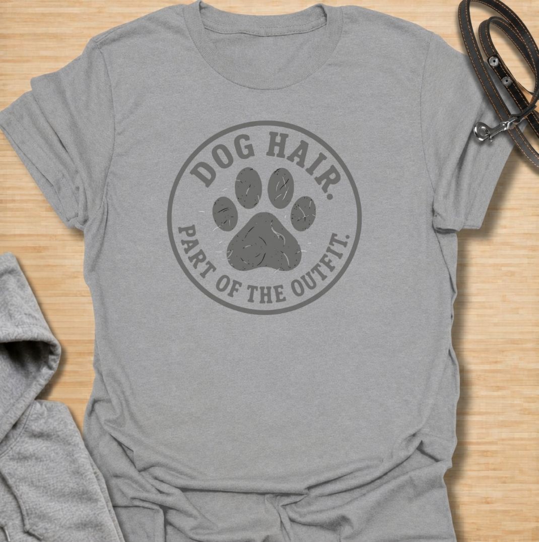 A funny dog T-shirt for anyone who has accepted that pet hair is simply part of everyday life. Featuring the phrase “Dog Hair. Part of the Outfit.” with a paw print graphic, this design is a relatable choice for dog owners who are permanently covered in a little extra fur. Perfect for dog moms, dog dads, rescue dog owners, and anyone who wears their dog’s hair with pride. A simple everyday tee for fans of dog humor, pet lover gifts, and general dog designs.