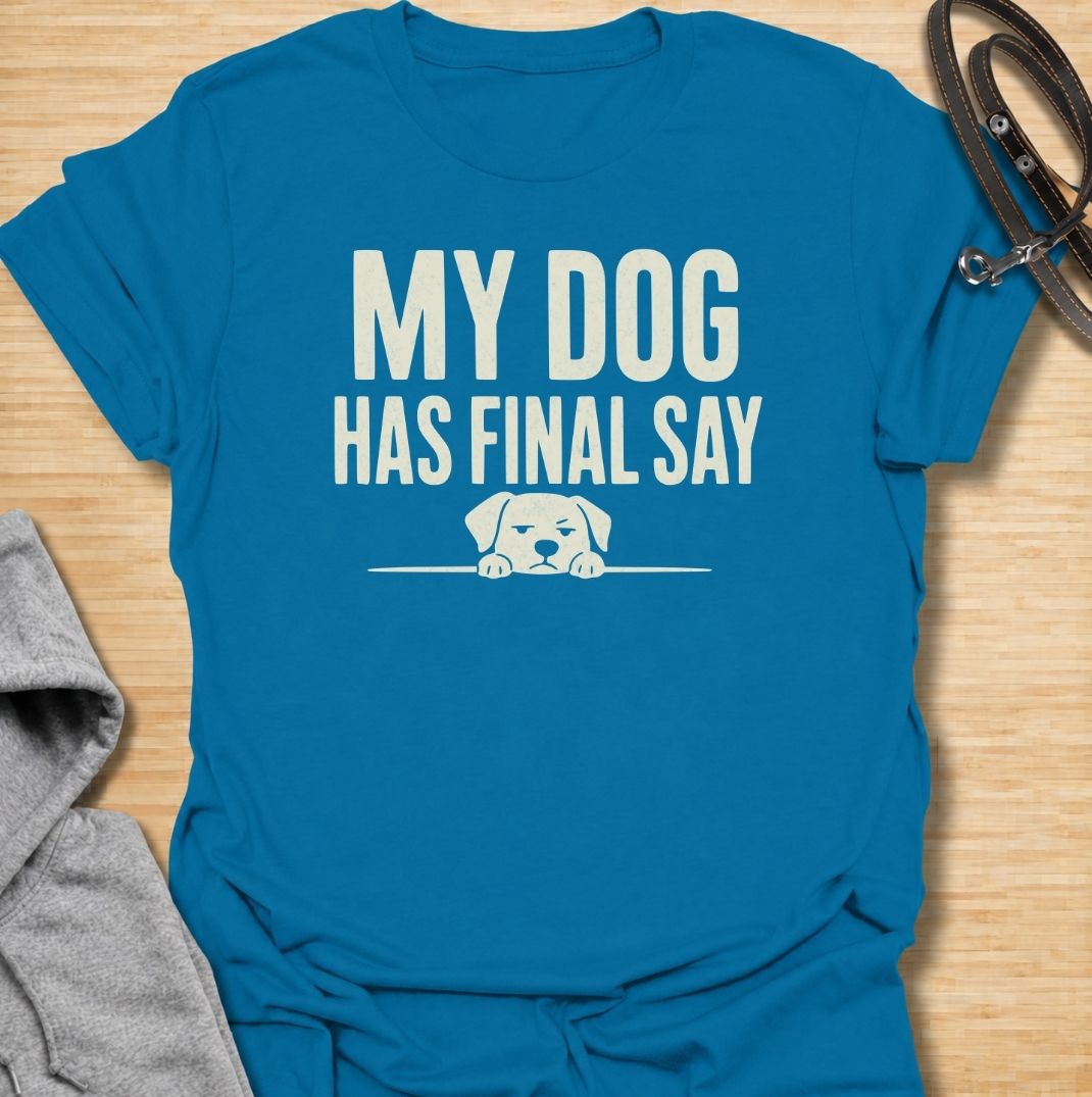 A funny dog T-shirt for anyone who knows who really makes the decisions at home. Featuring the phrase “My Dog Has Final Say” with a simple peeking dog graphic, this design captures the everyday reality of living with a very opinionated four-legged family member. Perfect for dog moms, dog dads, rescue dog owners, and anyone whose plans regularly require canine approval. A clean, playful everyday tee for fans of dog humor, funny pet sayings, and general dog lover gifts.