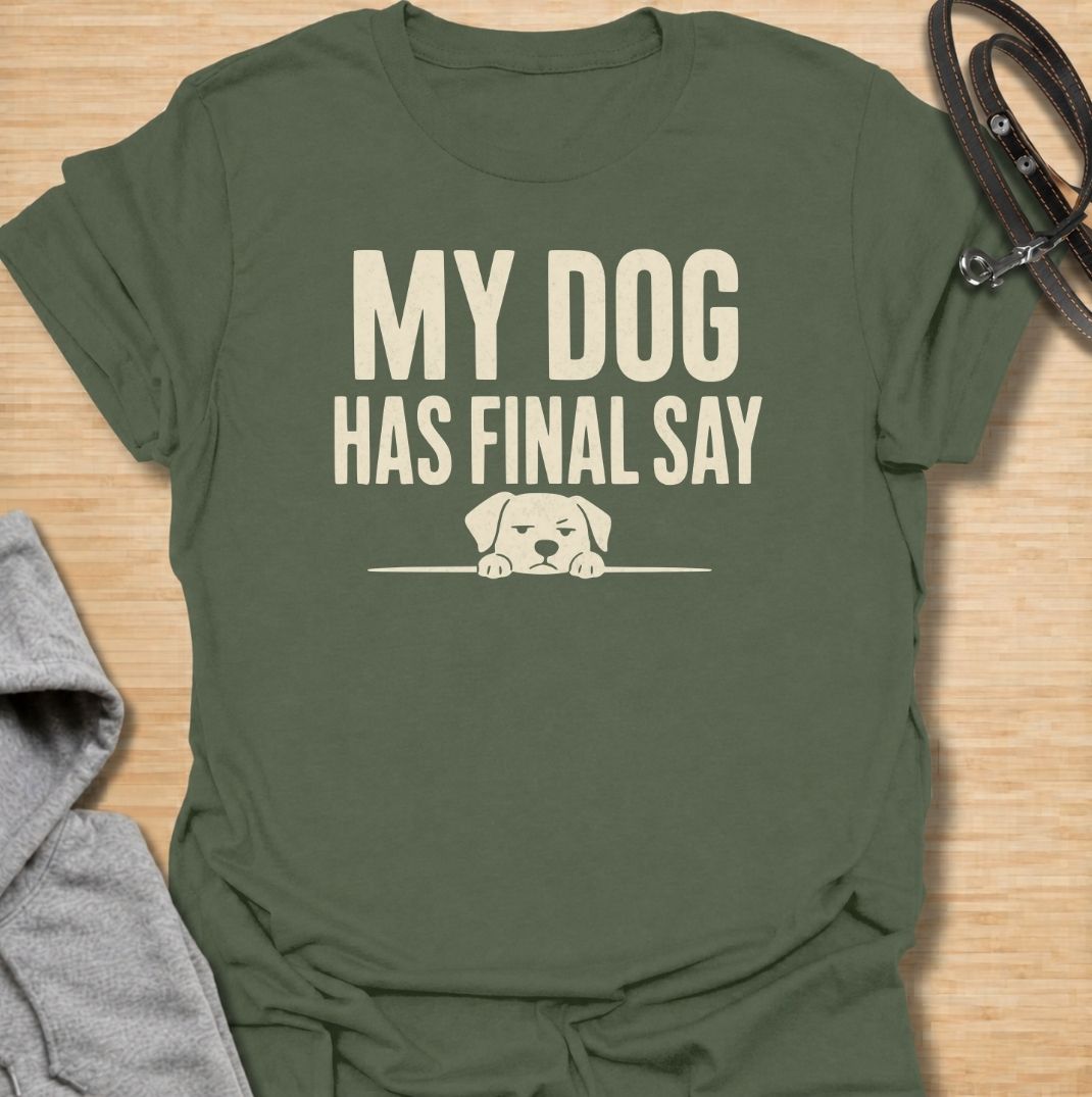 A funny dog T-shirt for anyone who knows who really makes the decisions at home. Featuring the phrase “My Dog Has Final Say” with a simple peeking dog graphic, this design captures the everyday reality of living with a very opinionated four-legged family member. Perfect for dog moms, dog dads, rescue dog owners, and anyone whose plans regularly require canine approval. A clean, playful everyday tee for fans of dog humor, funny pet sayings, and general dog lover gifts.