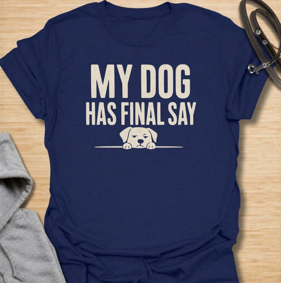 A funny dog T-shirt for anyone who knows who really makes the decisions at home. Featuring the phrase “My Dog Has Final Say” with a simple peeking dog graphic, this design captures the everyday reality of living with a very opinionated four-legged family member. Perfect for dog moms, dog dads, rescue dog owners, and anyone whose plans regularly require canine approval. A clean, playful everyday tee for fans of dog humor, funny pet sayings, and general dog lover gifts.