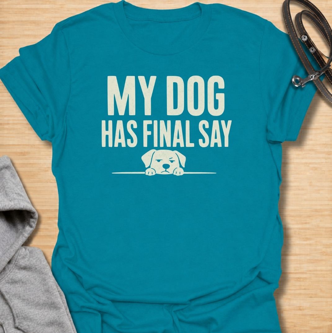 A funny dog T-shirt for anyone who knows who really makes the decisions at home. Featuring the phrase “My Dog Has Final Say” with a simple peeking dog graphic, this design captures the everyday reality of living with a very opinionated four-legged family member. Perfect for dog moms, dog dads, rescue dog owners, and anyone whose plans regularly require canine approval. A clean, playful everyday tee for fans of dog humor, funny pet sayings, and general dog lover gifts.