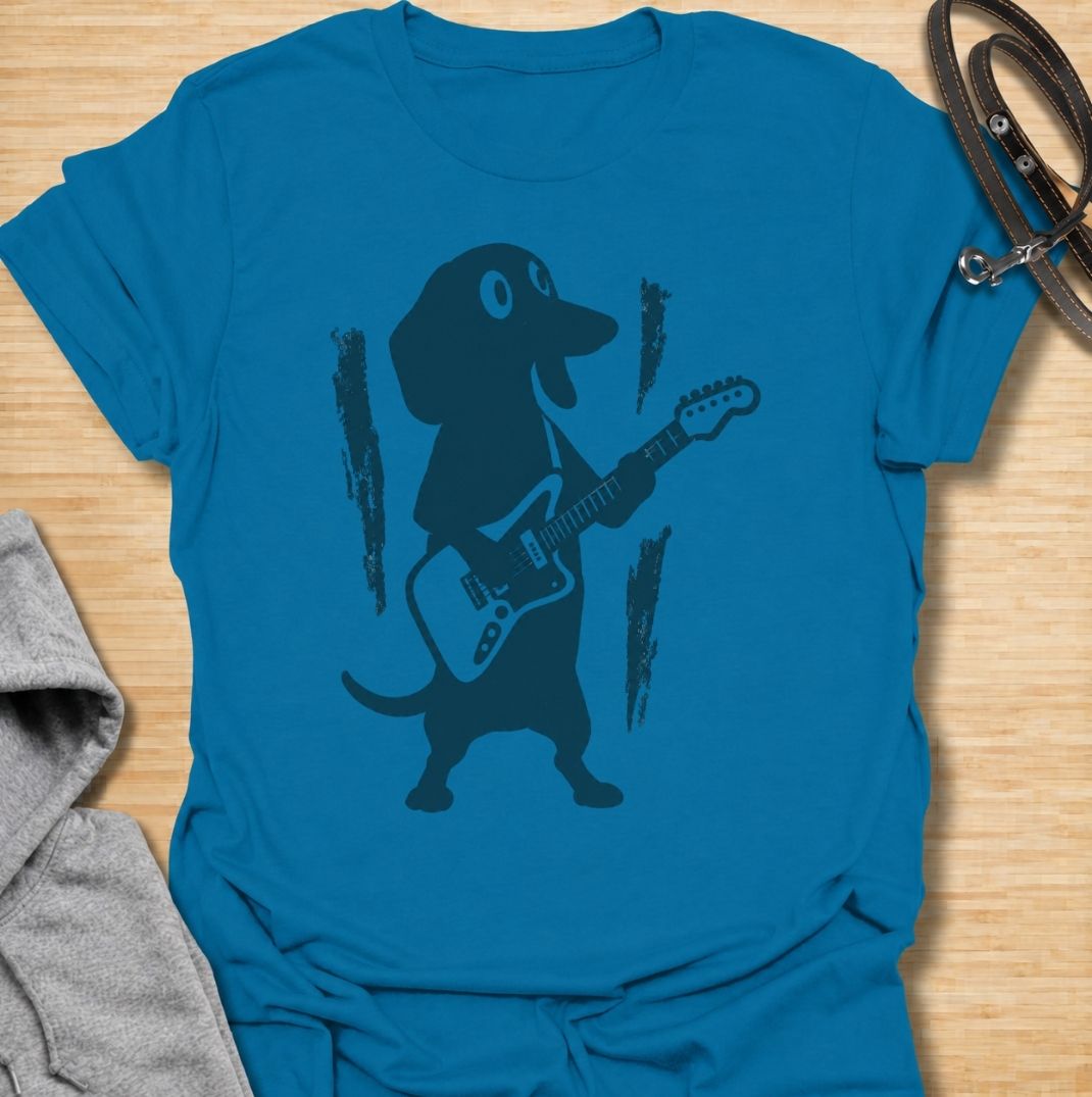 A fun dachshund T-shirt for dog lovers who know their little sausage dog has serious star power. Featuring a bold dachshund playing electric guitar, this design gives the breed a playful rock-and-roll twist without relying on text. Perfect for dachshund moms, dachshund dads, music lovers, and anyone who likes quirky breed-specific dog shirts. A strong everyday graphic tee for fans of doxies, wiener dogs, and dachshunds with big personality.