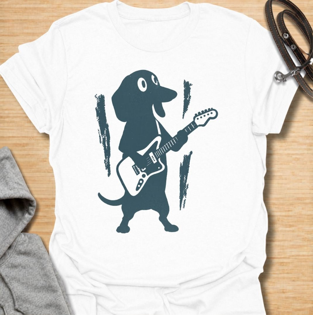 A fun dachshund T-shirt for dog lovers who know their little sausage dog has serious star power. Featuring a bold dachshund playing electric guitar, this design gives the breed a playful rock-and-roll twist without relying on text. Perfect for dachshund moms, dachshund dads, music lovers, and anyone who likes quirky breed-specific dog shirts. A strong everyday graphic tee for fans of doxies, wiener dogs, and dachshunds with big personality.