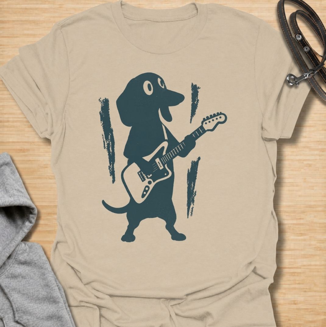 A fun dachshund T-shirt for dog lovers who know their little sausage dog has serious star power. Featuring a bold dachshund playing electric guitar, this design gives the breed a playful rock-and-roll twist without relying on text. Perfect for dachshund moms, dachshund dads, music lovers, and anyone who likes quirky breed-specific dog shirts. A strong everyday graphic tee for fans of doxies, wiener dogs, and dachshunds with big personality.