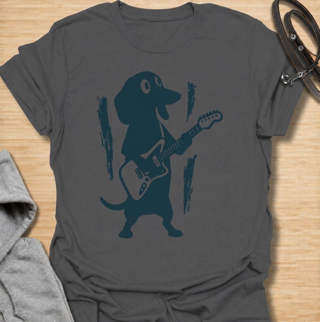 A fun dachshund T-shirt for dog lovers who know their little sausage dog has serious star power. Featuring a bold dachshund playing electric guitar, this design gives the breed a playful rock-and-roll twist without relying on text. Perfect for dachshund moms, dachshund dads, music lovers, and anyone who likes quirky breed-specific dog shirts. A strong everyday graphic tee for fans of doxies, wiener dogs, and dachshunds with big personality.