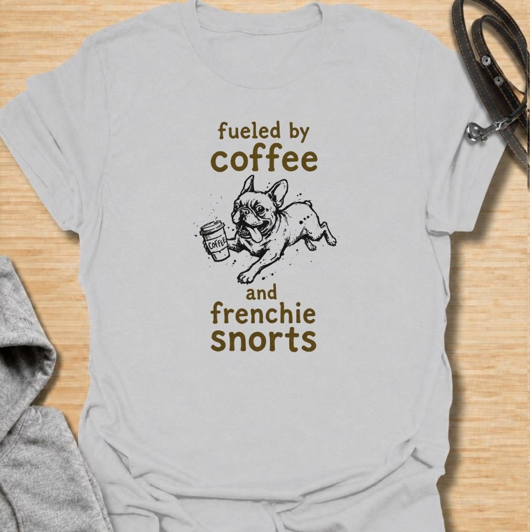 A funny French Bulldog T-shirt for anyone powered by caffeine and Frenchie chaos. Featuring the phrase “Fueled by Coffee and Frenchie Snorts” with a playful French Bulldog carrying a coffee cup, this design combines two everyday favorites in one lighthearted graphic. Perfect for Frenchie moms, Frenchie dads, coffee lovers, and anyone familiar with those unmistakable bulldog snorts. A fun everyday tee for fans of French Bulldog humor, coffee jokes, and breed-specific dog gifts.