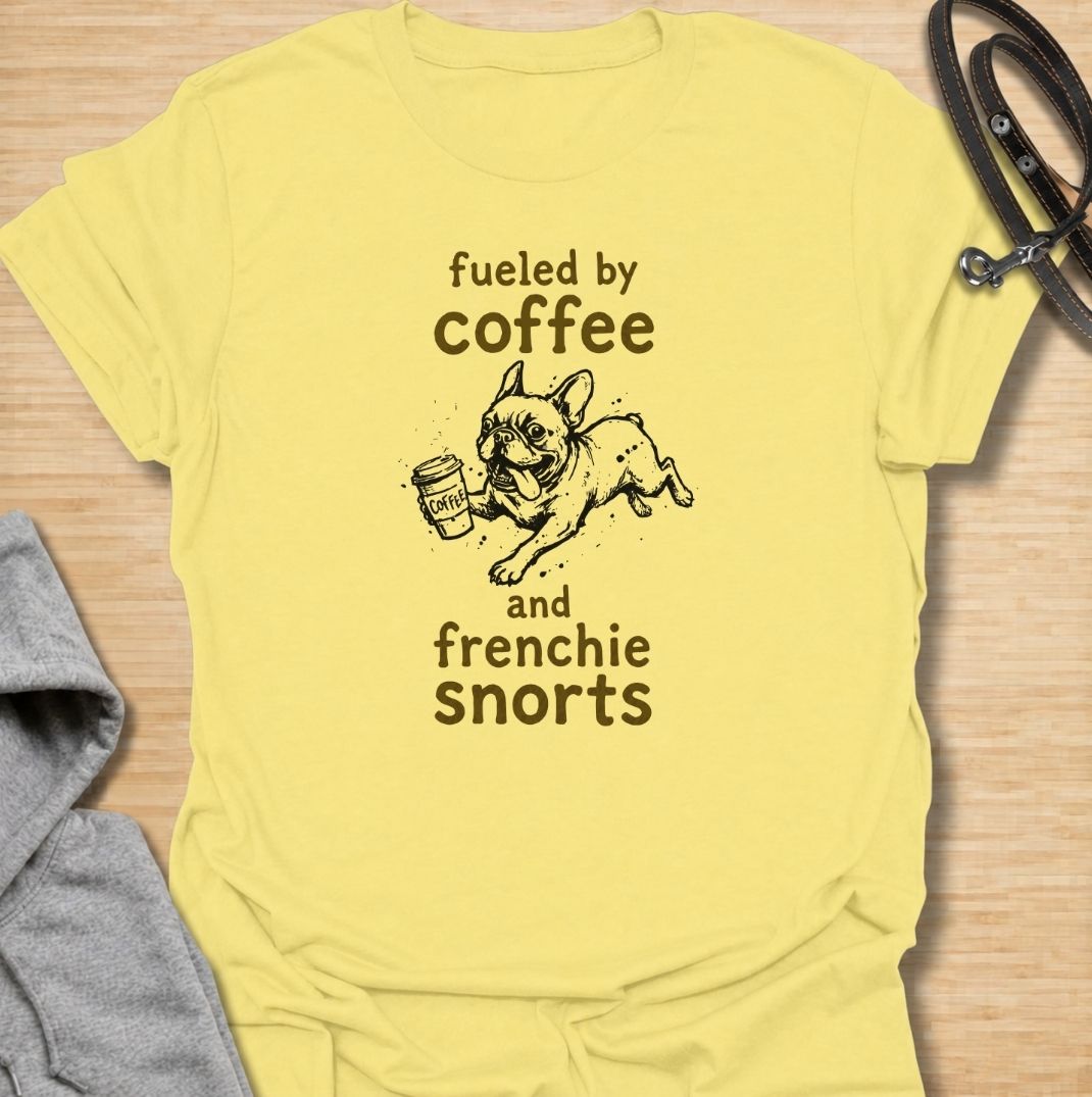 A funny French Bulldog T-shirt for anyone powered by caffeine and Frenchie chaos. Featuring the phrase “Fueled by Coffee and Frenchie Snorts” with a playful French Bulldog carrying a coffee cup, this design combines two everyday favorites in one lighthearted graphic. Perfect for Frenchie moms, Frenchie dads, coffee lovers, and anyone familiar with those unmistakable bulldog snorts. A fun everyday tee for fans of French Bulldog humor, coffee jokes, and breed-specific dog gifts.