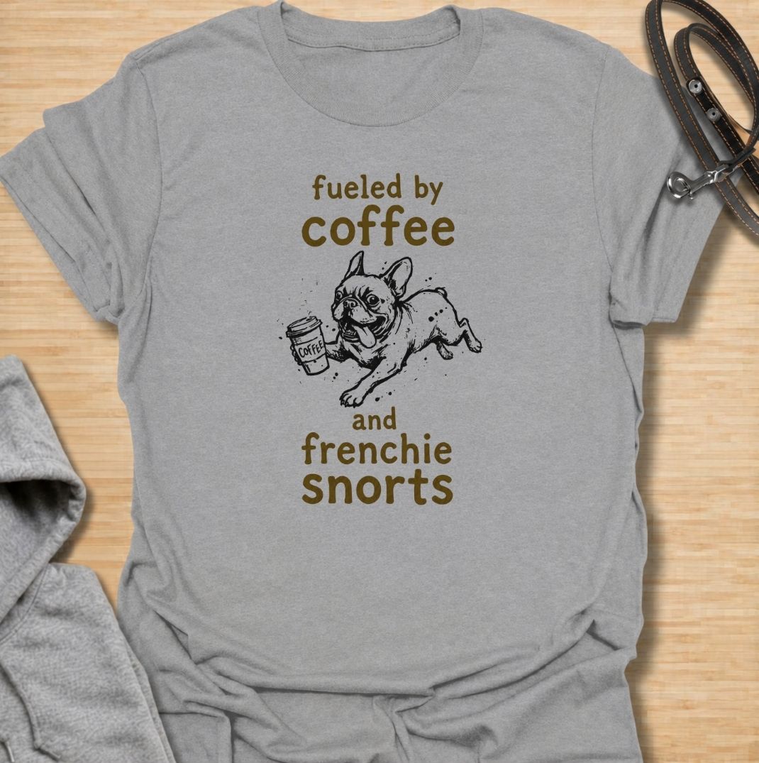 A funny French Bulldog T-shirt for anyone powered by caffeine and Frenchie chaos. Featuring the phrase “Fueled by Coffee and Frenchie Snorts” with a playful French Bulldog carrying a coffee cup, this design combines two everyday favorites in one lighthearted graphic. Perfect for Frenchie moms, Frenchie dads, coffee lovers, and anyone familiar with those unmistakable bulldog snorts. A fun everyday tee for fans of French Bulldog humor, coffee jokes, and breed-specific dog gifts.