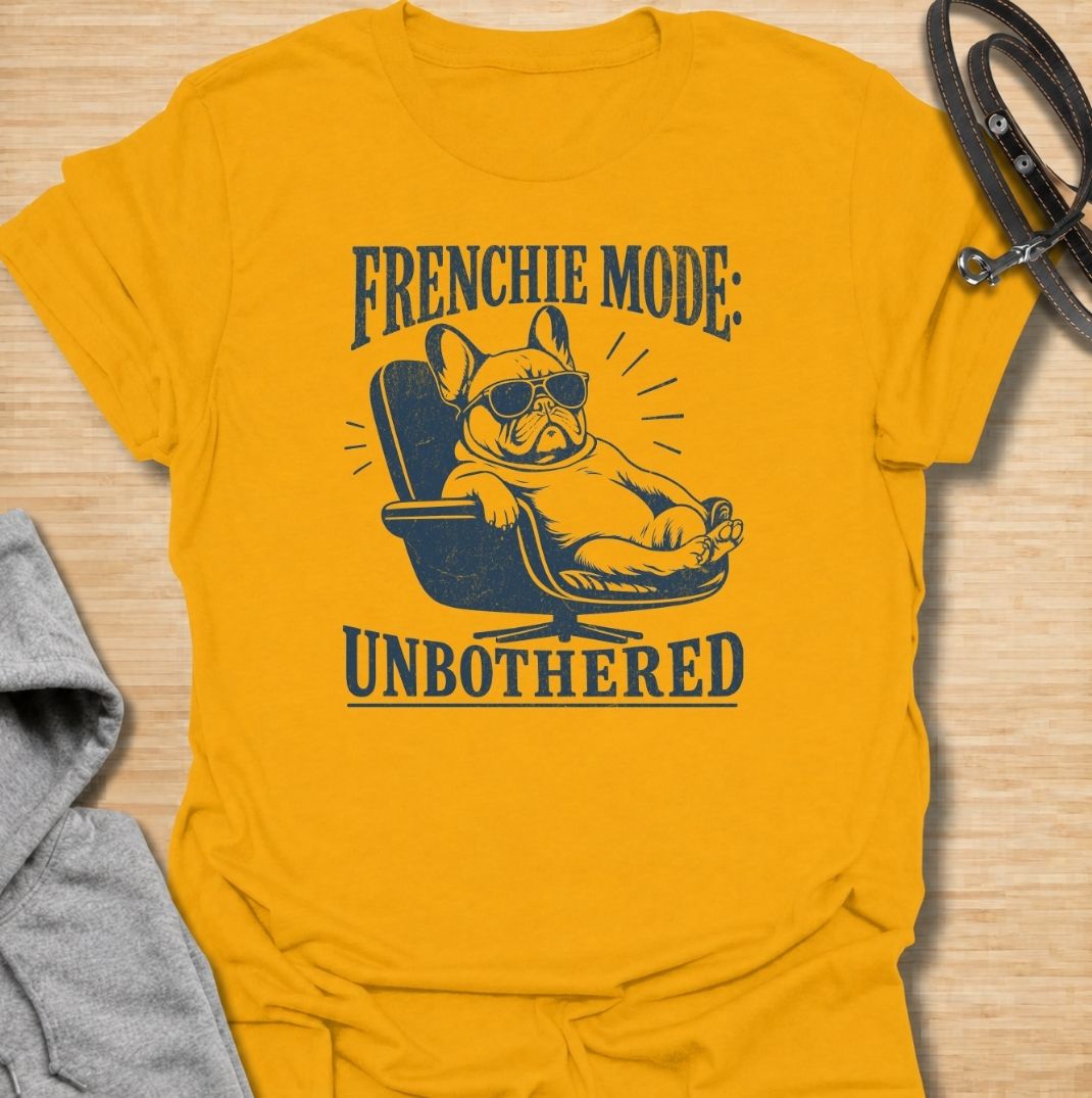 A funny French Bulldog T-shirt for anyone who knows a Frenchie can look completely relaxed while ignoring everything around them. Featuring the phrase “Frenchie Mode: Unbothered” with a laid-back bulldog illustration, this design captures the breed’s cool, stubborn personality perfectly. Ideal for Frenchie moms, Frenchie dads, bulldog lovers, and anyone who appreciates a dog with attitude. A playful everyday tee for fans of French Bulldog humor, relaxed dog vibes, and breed-specific gifts.