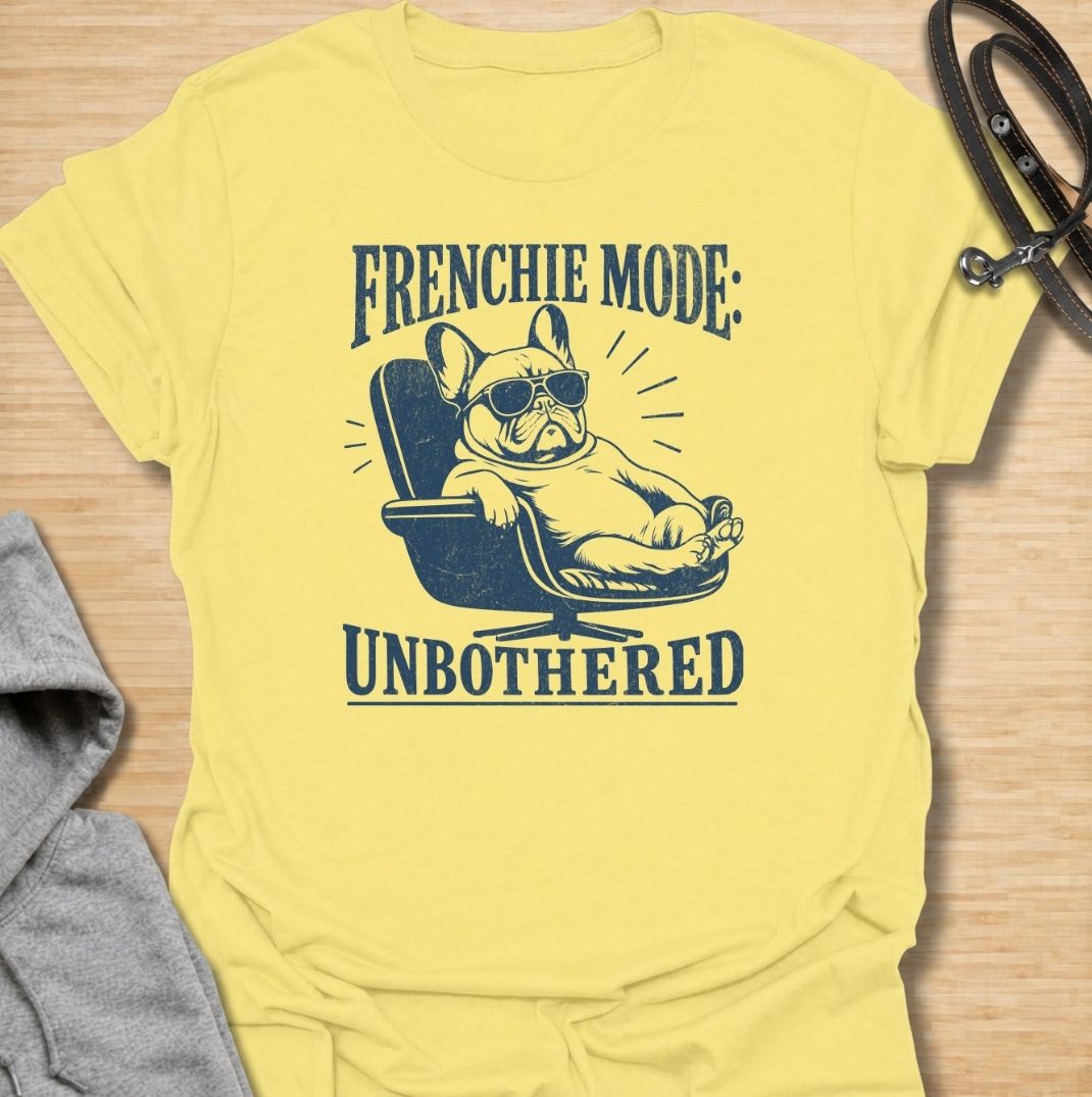 A funny French Bulldog T-shirt for anyone who knows a Frenchie can look completely relaxed while ignoring everything around them. Featuring the phrase “Frenchie Mode: Unbothered” with a laid-back bulldog illustration, this design captures the breed’s cool, stubborn personality perfectly. Ideal for Frenchie moms, Frenchie dads, bulldog lovers, and anyone who appreciates a dog with attitude. A playful everyday tee for fans of French Bulldog humor, relaxed dog vibes, and breed-specific gifts.