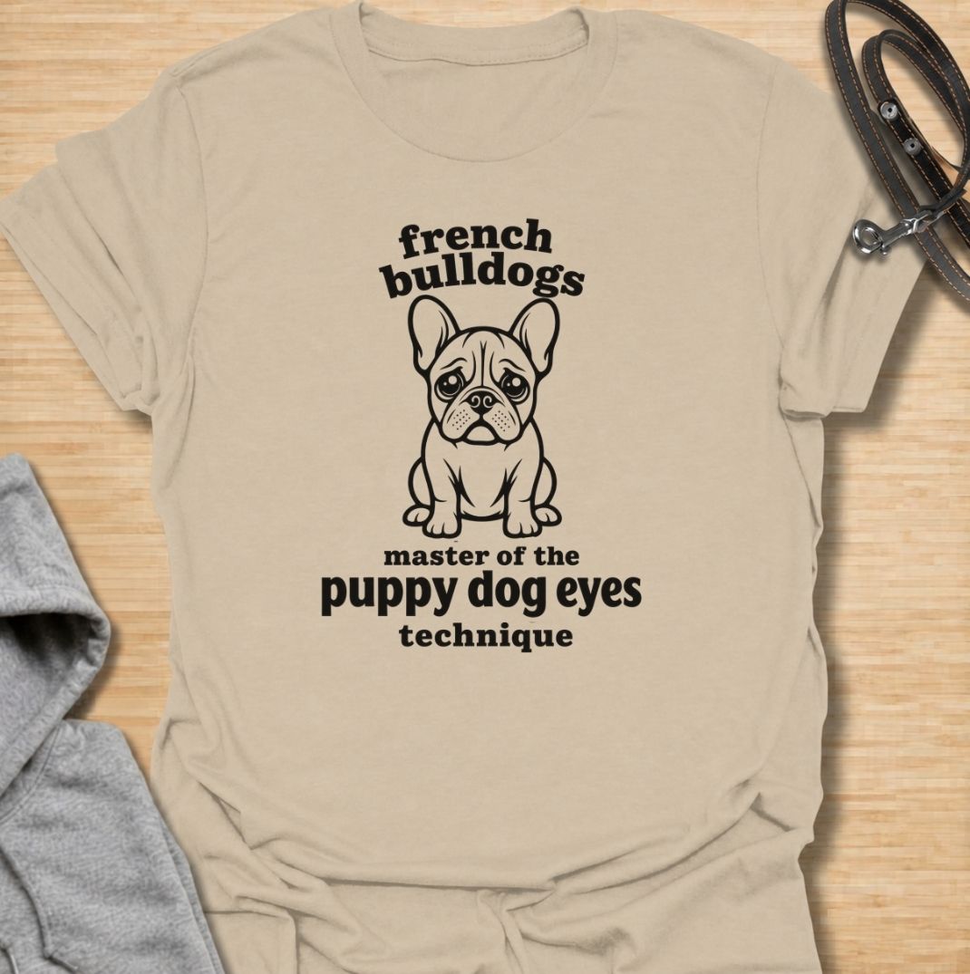 A funny French Bulldog T-shirt for anyone who knows those big eyes can get away with almost anything. Featuring the phrase “French Bulldogs — Master of the Puppy Dog Eyes Technique” with a cute Frenchie illustration, this design celebrates one of the breed’s most persuasive talents. Perfect for Frenchie moms, Frenchie dads, bulldog lovers, and anyone who regularly gives in to that irresistible stare. A playful everyday tee for fans of French Bulldog humor, cute dog sayings, and breed-specific gifts.