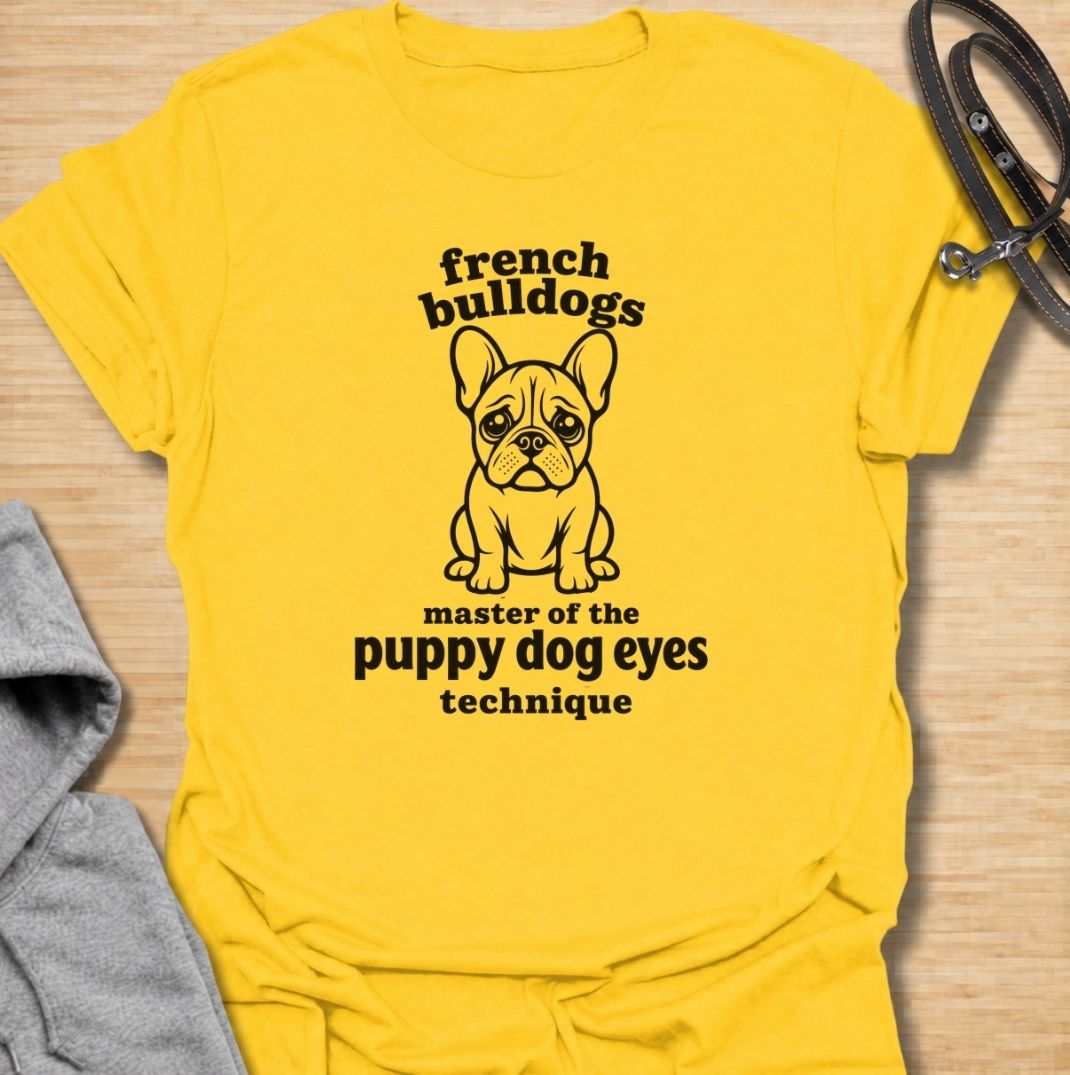 A funny French Bulldog T-shirt for anyone who knows those big eyes can get away with almost anything. Featuring the phrase “French Bulldogs — Master of the Puppy Dog Eyes Technique” with a cute Frenchie illustration, this design celebrates one of the breed’s most persuasive talents. Perfect for Frenchie moms, Frenchie dads, bulldog lovers, and anyone who regularly gives in to that irresistible stare. A playful everyday tee for fans of French Bulldog humor, cute dog sayings, and breed-specific gifts.