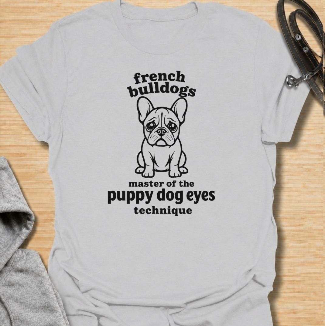 A funny French Bulldog T-shirt for anyone who knows those big eyes can get away with almost anything. Featuring the phrase “French Bulldogs — Master of the Puppy Dog Eyes Technique” with a cute Frenchie illustration, this design celebrates one of the breed’s most persuasive talents. Perfect for Frenchie moms, Frenchie dads, bulldog lovers, and anyone who regularly gives in to that irresistible stare. A playful everyday tee for fans of French Bulldog humor, cute dog sayings, and breed-specific gifts.