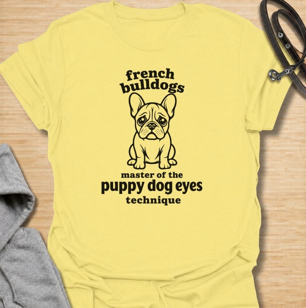 A funny French Bulldog T-shirt for anyone who knows those big eyes can get away with almost anything. Featuring the phrase “French Bulldogs — Master of the Puppy Dog Eyes Technique” with a cute Frenchie illustration, this design celebrates one of the breed’s most persuasive talents. Perfect for Frenchie moms, Frenchie dads, bulldog lovers, and anyone who regularly gives in to that irresistible stare. A playful everyday tee for fans of French Bulldog humor, cute dog sayings, and breed-specific gifts.