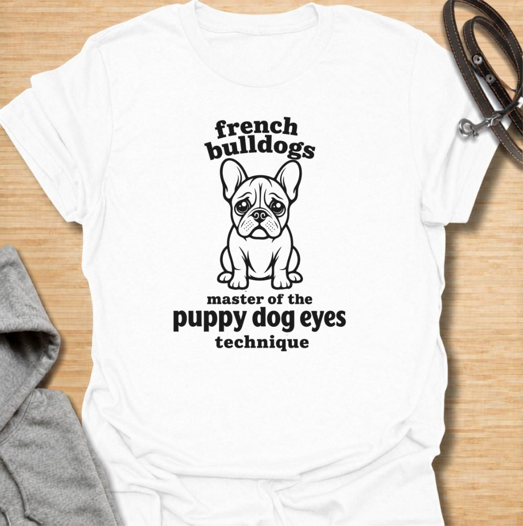 A funny French Bulldog T-shirt for anyone who knows those big eyes can get away with almost anything. Featuring the phrase “French Bulldogs — Master of the Puppy Dog Eyes Technique” with a cute Frenchie illustration, this design celebrates one of the breed’s most persuasive talents. Perfect for Frenchie moms, Frenchie dads, bulldog lovers, and anyone who regularly gives in to that irresistible stare. A playful everyday tee for fans of French Bulldog humor, cute dog sayings, and breed-specific gifts.