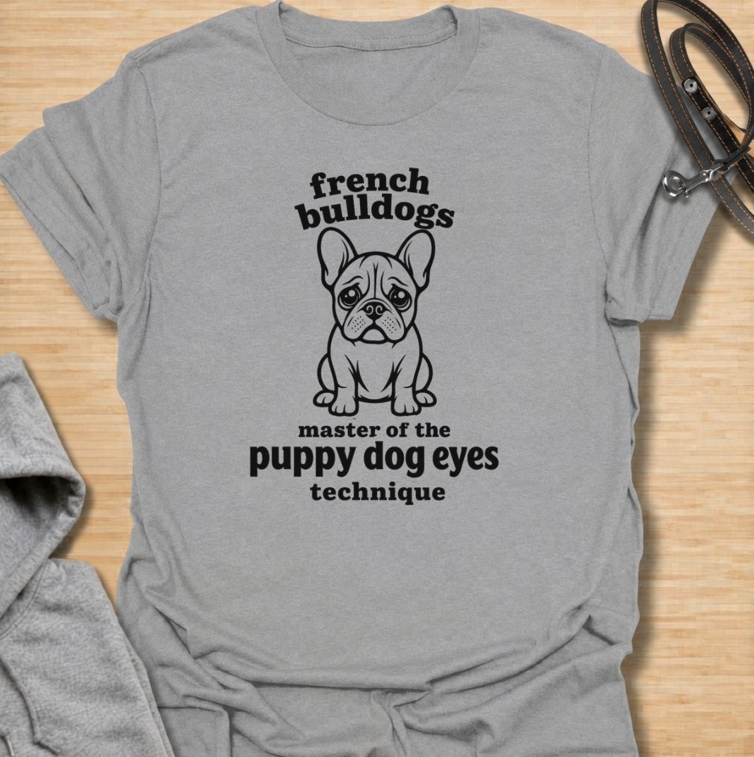 A funny French Bulldog T-shirt for anyone who knows those big eyes can get away with almost anything. Featuring the phrase “French Bulldogs — Master of the Puppy Dog Eyes Technique” with a cute Frenchie illustration, this design celebrates one of the breed’s most persuasive talents. Perfect for Frenchie moms, Frenchie dads, bulldog lovers, and anyone who regularly gives in to that irresistible stare. A playful everyday tee for fans of French Bulldog humor, cute dog sayings, and breed-specific gifts.