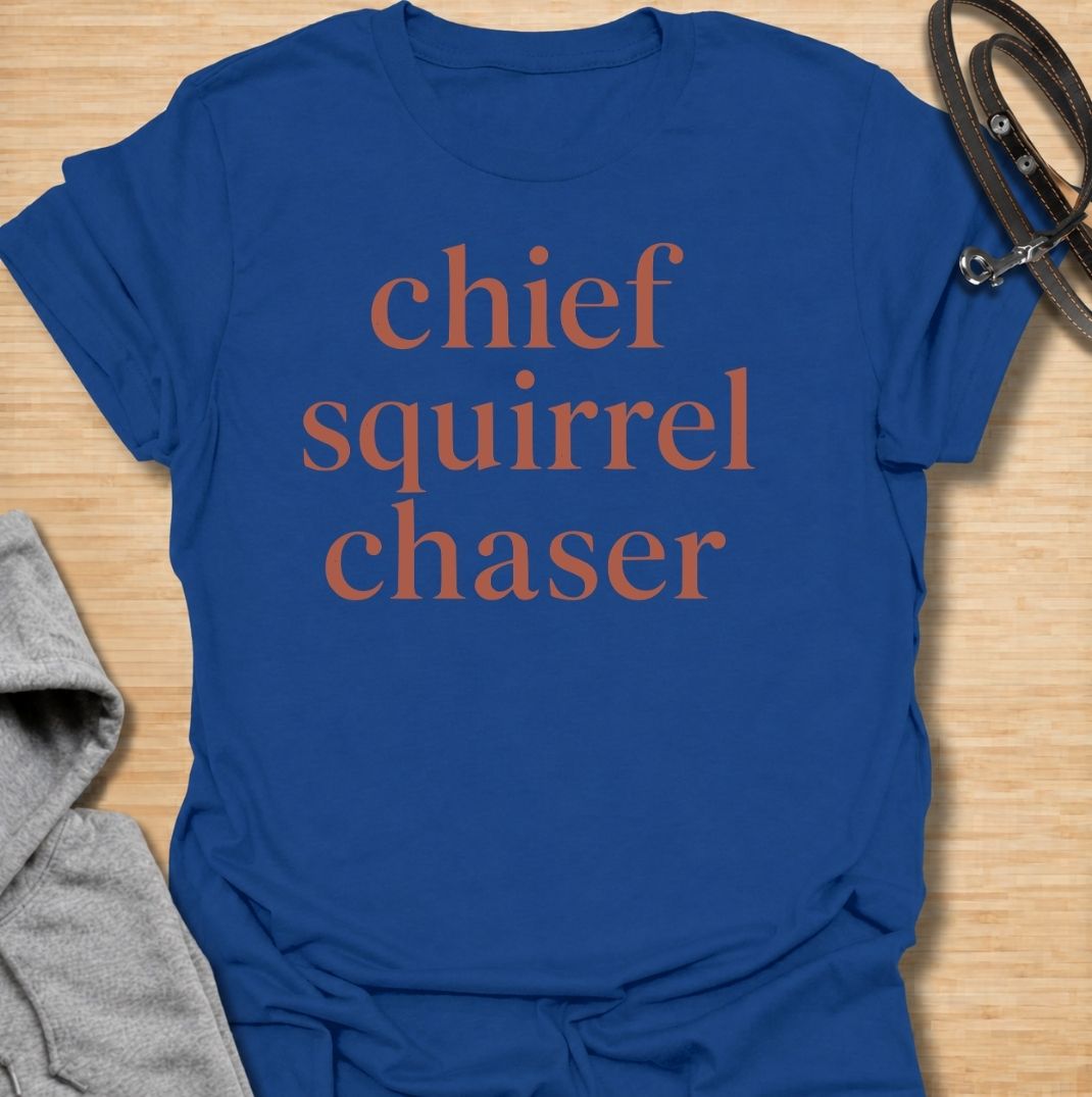 A funny dog T-shirt for anyone whose dog takes squirrel patrol very seriously. Featuring the phrase “Chief Squirrel Chaser” in a clean, bold text-only design, this shirt is perfect for dogs who treat every backyard visitor like an emergency. Ideal for dog moms, dog dads, rescue dog owners, and anyone familiar with sudden squirrel-fueled chaos. A simple everyday tee for fans of dog humor, playful pet sayings, and general dog lover gifts.