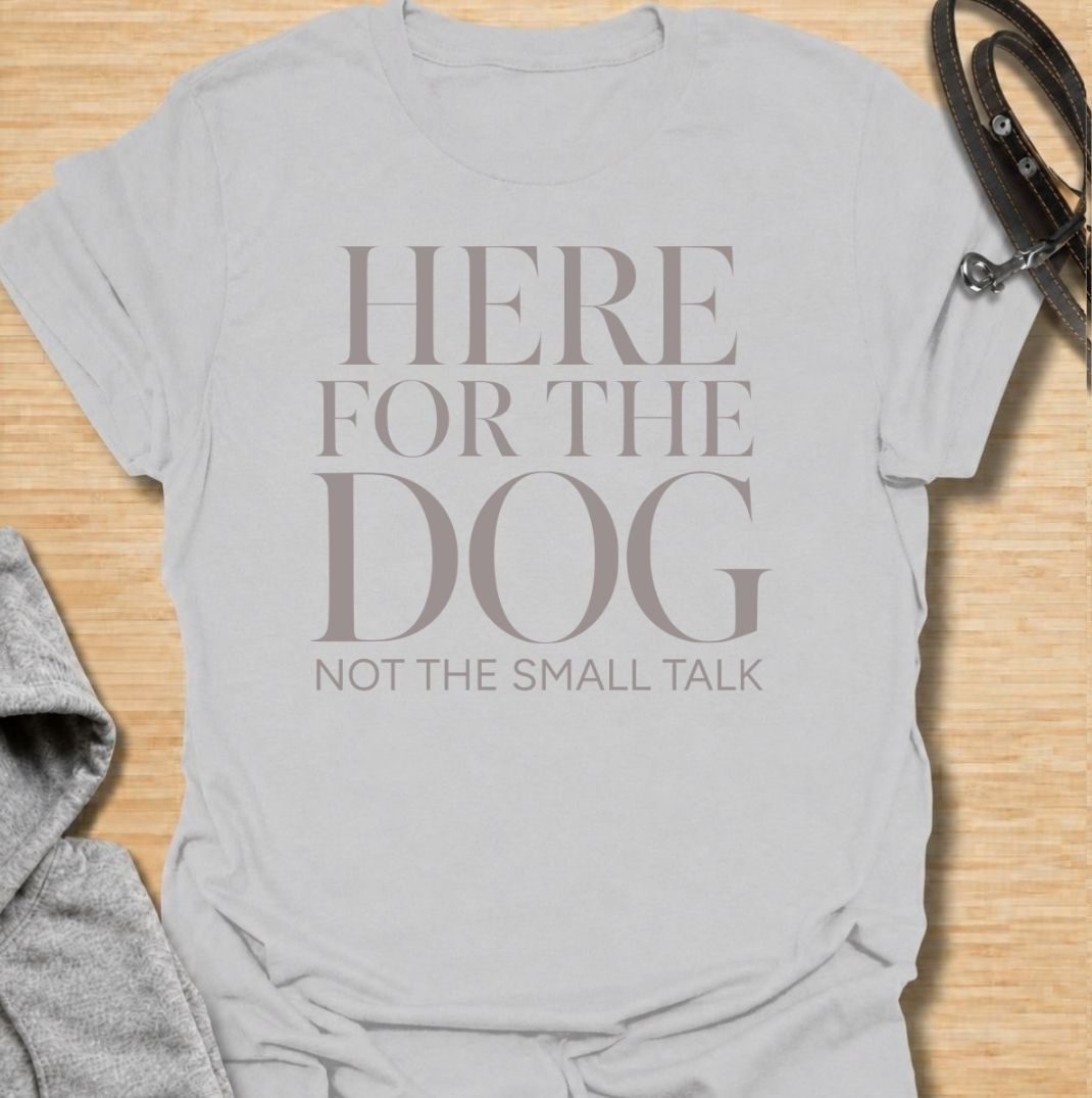 A funny dog T-shirt for anyone who would rather meet the dog than make small talk. Featuring the phrase “Here for the Dog, Not the Small Talk,” this clean text-based design speaks directly to introverted dog lovers and anyone who prefers four-legged company. Perfect for dog moms, dog dads, rescue dog owners, and anyone who heads straight for the dog at every gathering. A simple everyday tee for fans of dry dog humor, pet parent sayings, and general dog lover gifts.