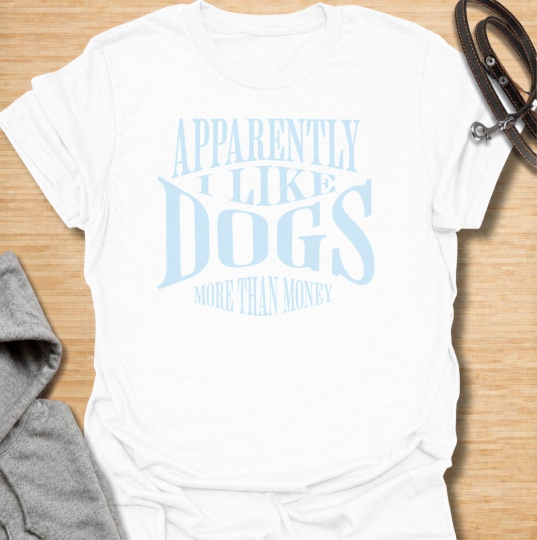A funny dog T-shirt for anyone who knows exactly where their priorities lie. Featuring the phrase “Apparently I Like Dogs More Than Money,” this bold text-based design is perfect for devoted dog people who happily spend on treats, toys, beds, and anything else their pet might need. Ideal for dog moms, dog dads, rescue dog owners, and anyone whose bank balance regularly loses to their four-legged companion. A playful everyday tee for fans of dog humor, funny pet sayings, and general dog lover gifts.