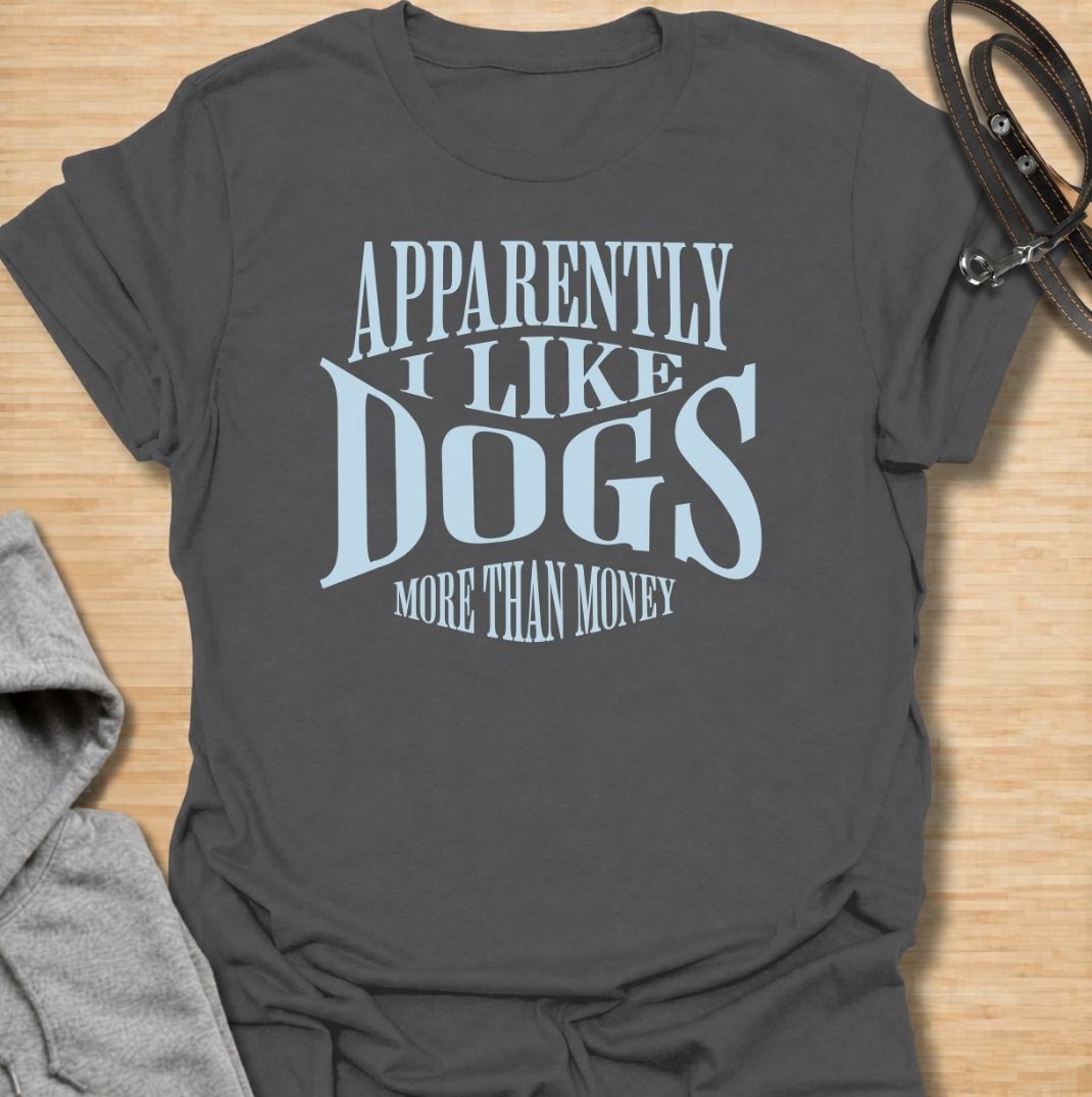 A funny dog T-shirt for anyone who knows exactly where their priorities lie. Featuring the phrase “Apparently I Like Dogs More Than Money,” this bold text-based design is perfect for devoted dog people who happily spend on treats, toys, beds, and anything else their pet might need. Ideal for dog moms, dog dads, rescue dog owners, and anyone whose bank balance regularly loses to their four-legged companion. A playful everyday tee for fans of dog humor, funny pet sayings, and general dog lover gifts.