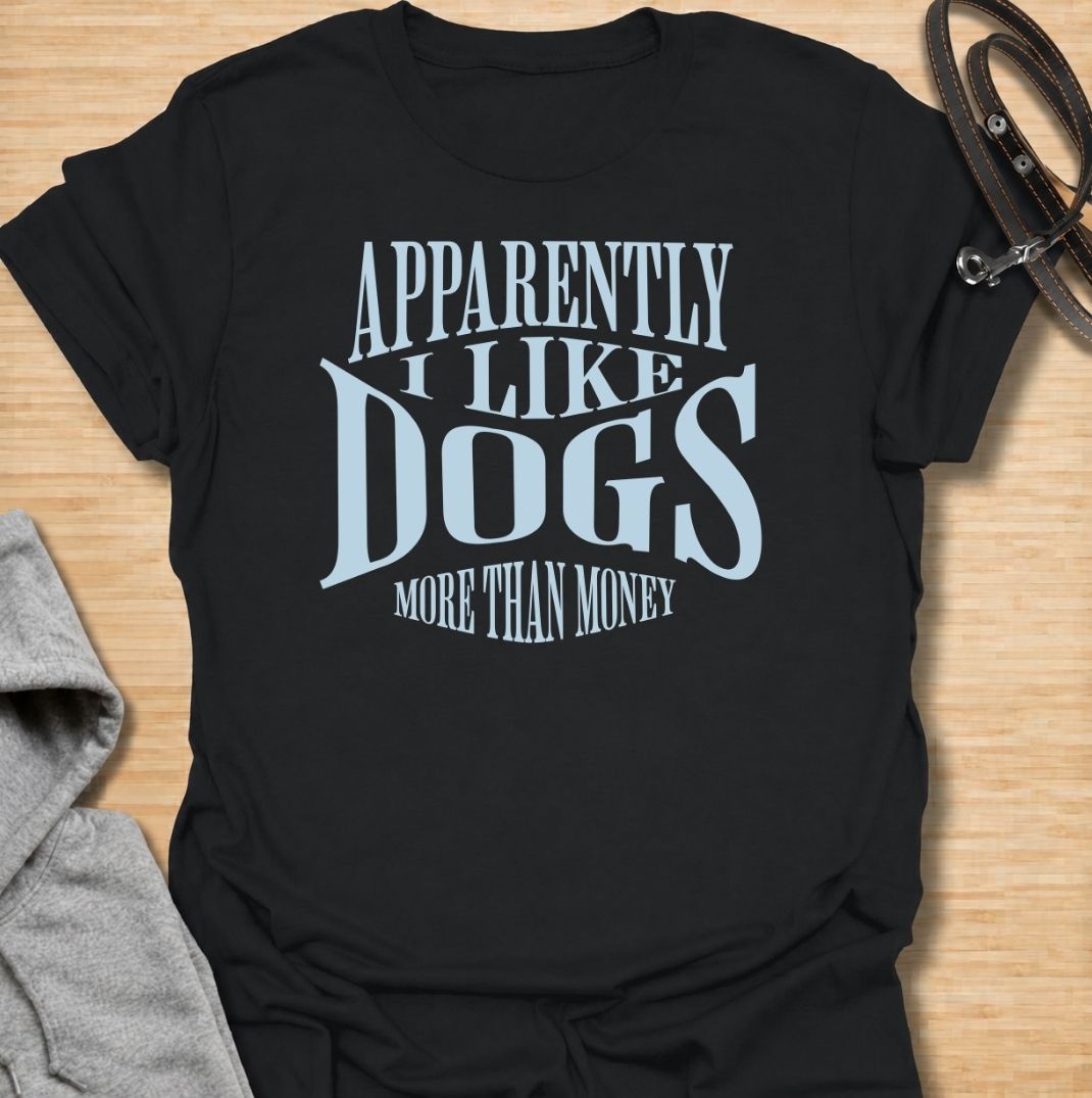 A funny dog T-shirt for anyone who knows exactly where their priorities lie. Featuring the phrase “Apparently I Like Dogs More Than Money,” this bold text-based design is perfect for devoted dog people who happily spend on treats, toys, beds, and anything else their pet might need. Ideal for dog moms, dog dads, rescue dog owners, and anyone whose bank balance regularly loses to their four-legged companion. A playful everyday tee for fans of dog humor, funny pet sayings, and general dog lover gifts.