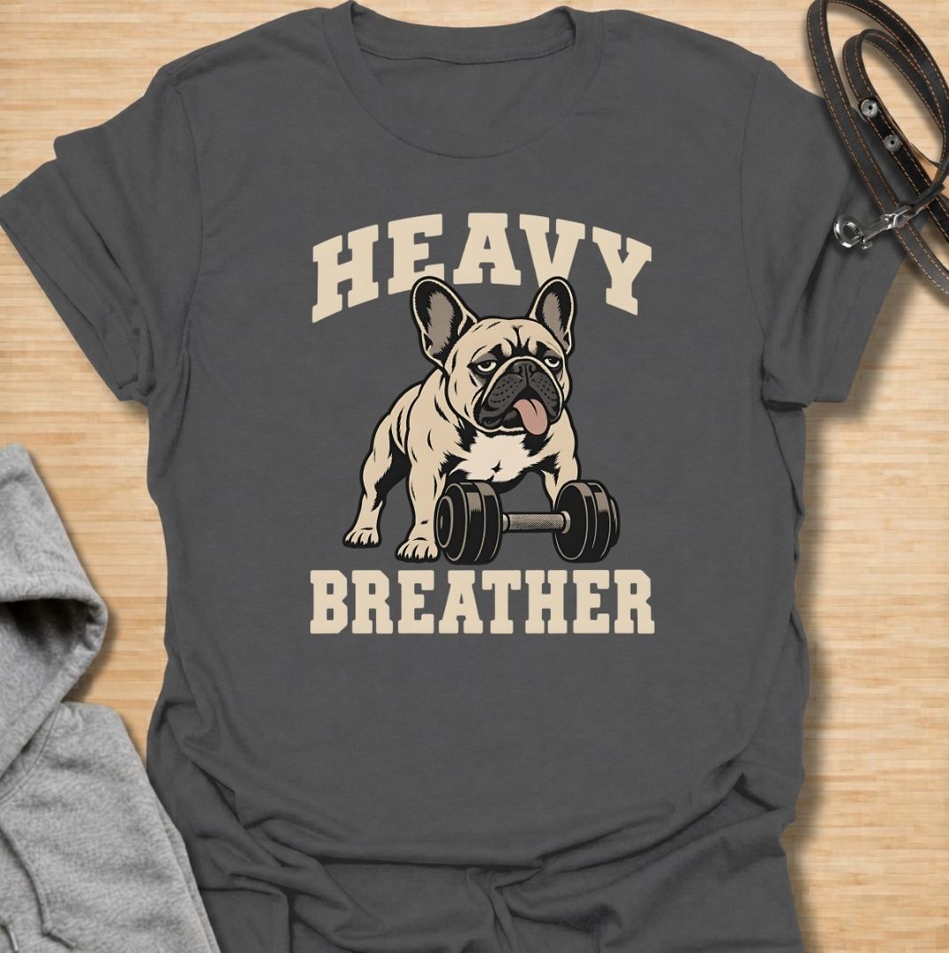 A funny French Bulldog T-shirt for anyone who knows a Frenchie can sound like they’ve finished a workout before it has even started. Featuring the phrase “Heavy Breather” with a French Bulldog and dumbbell graphic, this design combines gym humor with one of the breed’s most recognizable traits. Perfect for Frenchie moms, Frenchie dads, gym lovers, and anyone who enjoys breed-specific dog humor. A playful everyday tee for fans of French Bulldog fitness jokes, funny dog shirts, and unique Frenchie gifts.