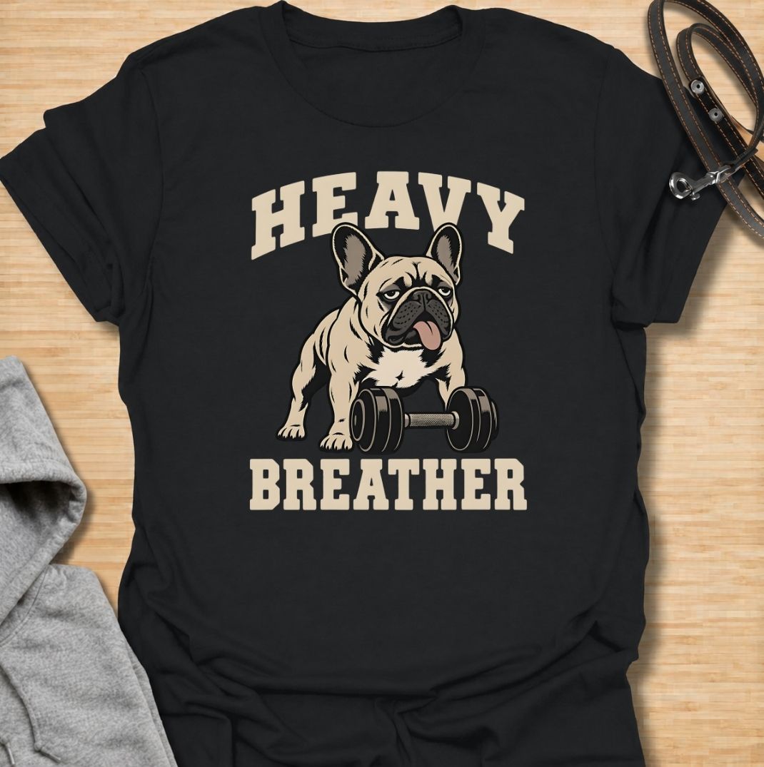 A funny French Bulldog T-shirt for anyone who knows a Frenchie can sound like they’ve finished a workout before it has even started. Featuring the phrase “Heavy Breather” with a French Bulldog and dumbbell graphic, this design combines gym humor with one of the breed’s most recognizable traits. Perfect for Frenchie moms, Frenchie dads, gym lovers, and anyone who enjoys breed-specific dog humor. A playful everyday tee for fans of French Bulldog fitness jokes, funny dog shirts, and unique Frenchie gifts.