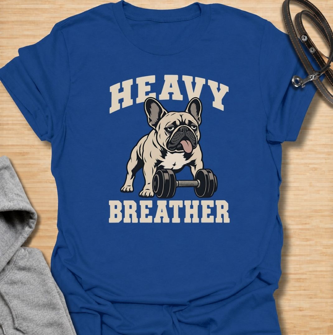 A funny French Bulldog T-shirt for anyone who knows a Frenchie can sound like they’ve finished a workout before it has even started. Featuring the phrase “Heavy Breather” with a French Bulldog and dumbbell graphic, this design combines gym humor with one of the breed’s most recognizable traits. Perfect for Frenchie moms, Frenchie dads, gym lovers, and anyone who enjoys breed-specific dog humor. A playful everyday tee for fans of French Bulldog fitness jokes, funny dog shirts, and unique Frenchie gifts.