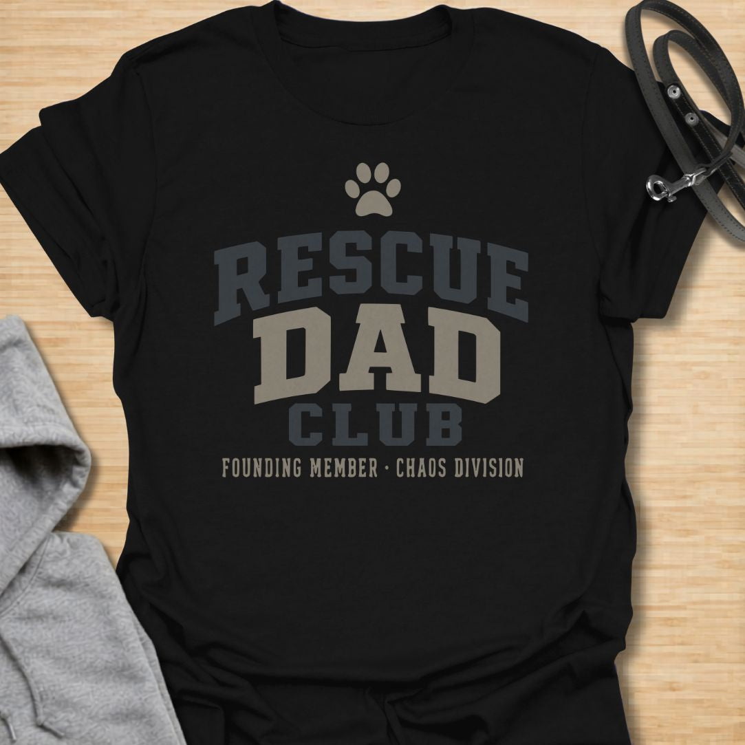 This Rescue Dad Club t-shirt is made for proud dog dads who know rescue dogs bring love, loyalty, and just the right amount of chaos. Featuring bold varsity-style lettering, a paw print, bone accents, and the phrase founding member chaos division, this design has a clean sporty look with a funny rescue-dog twist. Perfect for rescue dog dads, foster dog dads, shelter dog adopters, dog lovers, and anyone proudly raising a second-chance pup.