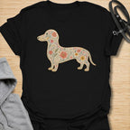 This Floral Dachshund t-shirt is made for doxie lovers who want a beautiful, botanical take on their favorite long dog. Featuring a dachshund silhouette filled with intricate flowers, leaves, vines, and vintage-style floral details, this design blends dog-lover charm with soft garden-inspired artwork. Perfect for dachshund moms, dachshund dads, wiener dog lovers, sausage dog fans, botanical art lovers, and anyone who loves both dogs and flowers.