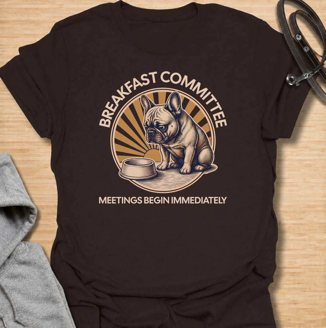 For French bulldogs who take breakfast very seriously and expect meetings to begin the second they wake up. This funny Frenchie T-shirt features the phrase “Breakfast Committee – Meetings Begin Immediately” with a wonderfully impatient bulldog waiting beside an empty bowl. Perfect for French bulldog owners who know mealtimes are less of a routine and more of a daily emergency. A fun vintage-style dog lover tee packed with classic Frenchie attitude.