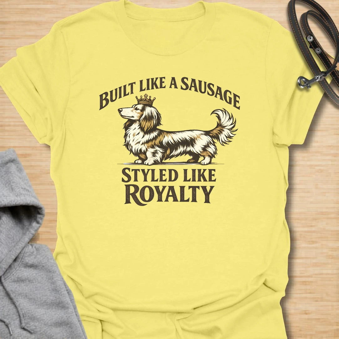This Built Like A Sausage Styled Like Royalty t-shirt is made for long-haired dachshund lovers who know their little dog has a funny shape and a very grand sense of self. Featuring an elegant long-haired doxie with a tiny crown and bold vintage-style lettering, this design has a polished breed-specific feel with plenty of humor. Perfect for dachshund moms, dachshund dads, long-haired doxie fans, wiener dog lovers, and anyone whose sausage dog