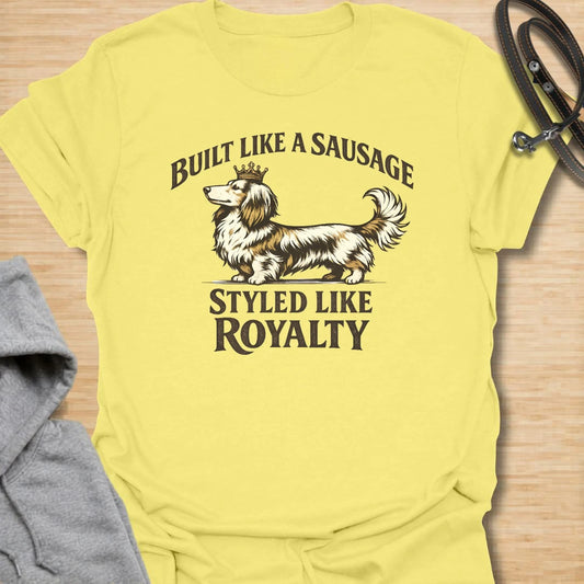 This Built Like A Sausage Styled Like Royalty t-shirt is made for long-haired dachshund lovers who know their little dog has a funny shape and a very grand sense of self. Featuring an elegant long-haired doxie with a tiny crown and bold vintage-style lettering, this design has a polished breed-specific feel with plenty of humor. Perfect for dachshund moms, dachshund dads, long-haired doxie fans, wiener dog lovers, and anyone whose sausage dog