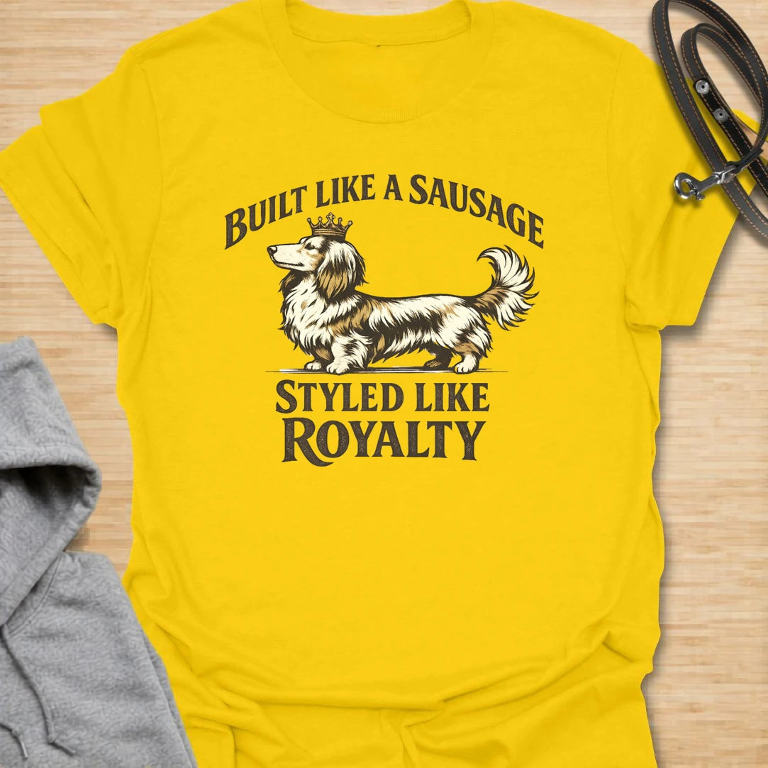 This Built Like A Sausage Styled Like Royalty t-shirt is made for long-haired dachshund lovers who know their little dog has a funny shape and a very grand sense of self. Featuring an elegant long-haired doxie with a tiny crown and bold vintage-style lettering, this design has a polished breed-specific feel with plenty of humor. Perfect for dachshund moms, dachshund dads, long-haired doxie fans, wiener dog lovers, and anyone whose sausage dog