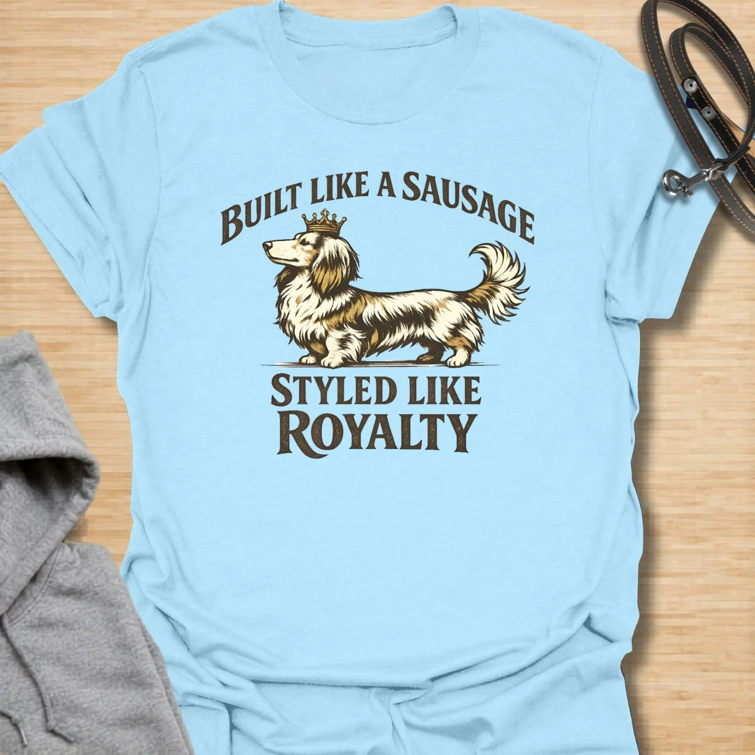 This Built Like A Sausage Styled Like Royalty t-shirt is made for long-haired dachshund lovers who know their little dog has a funny shape and a very grand sense of self. Featuring an elegant long-haired doxie with a tiny crown and bold vintage-style lettering, this design has a polished breed-specific feel with plenty of humor. Perfect for dachshund moms, dachshund dads, long-haired doxie fans, wiener dog lovers, and anyone whose sausage dog
