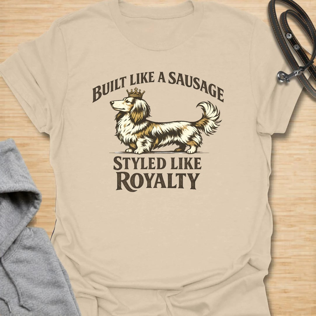 This Built Like A Sausage Styled Like Royalty t-shirt is made for long-haired dachshund lovers who know their little dog has a funny shape and a very grand sense of self. Featuring an elegant long-haired doxie with a tiny crown and bold vintage-style lettering, this design has a polished breed-specific feel with plenty of humor. Perfect for dachshund moms, dachshund dads, long-haired doxie fans, wiener dog lovers, and anyone whose sausage dog