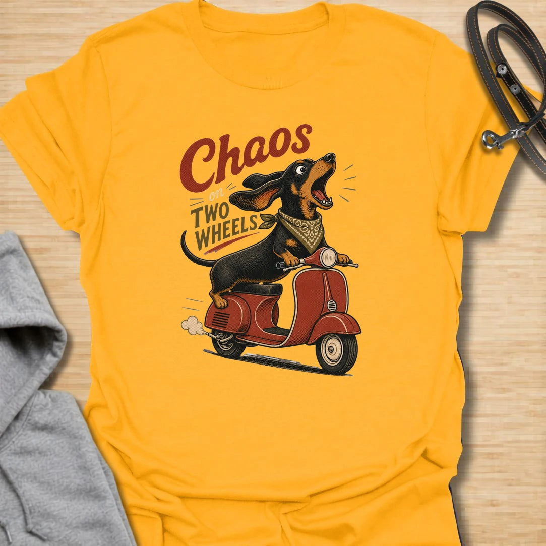 Chaos on two wheels dachshund t-shirt for anyone whose sausage dog seems to manage the household mayhem. This funny vintage-style design features a bold dachshund racing along on a scooter with retro lettering and plenty of doxie attitude. Perfect for dachshund moms, doxie dads, wiener dog lovers, and small dog owners who know chaos is part of the charm.