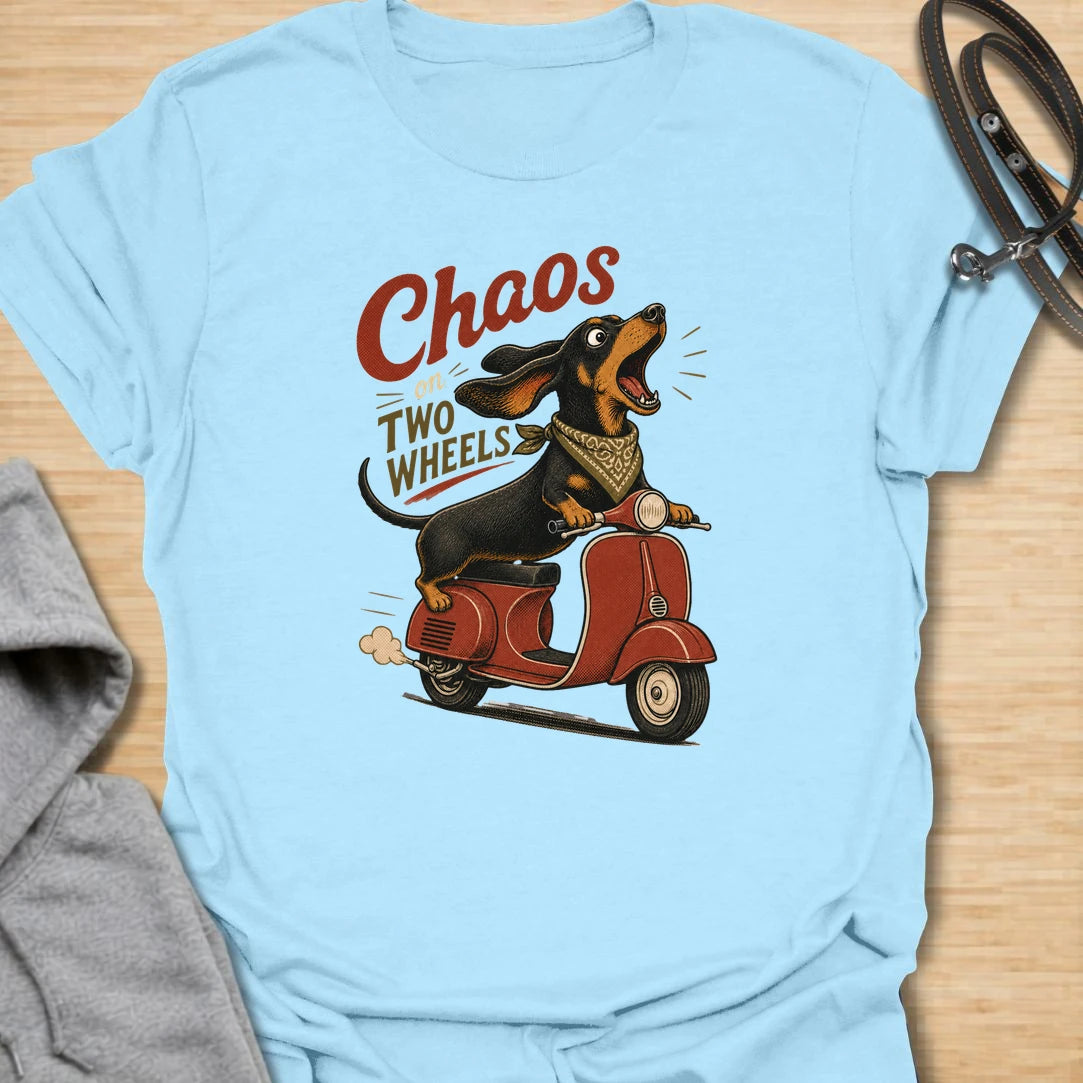 Chaos on two wheels dachshund t-shirt for anyone whose sausage dog seems to manage the household mayhem. This funny vintage-style design features a bold dachshund racing along on a scooter with retro lettering and plenty of doxie attitude. Perfect for dachshund moms, doxie dads, wiener dog lovers, and small dog owners who know chaos is part of the charm.
