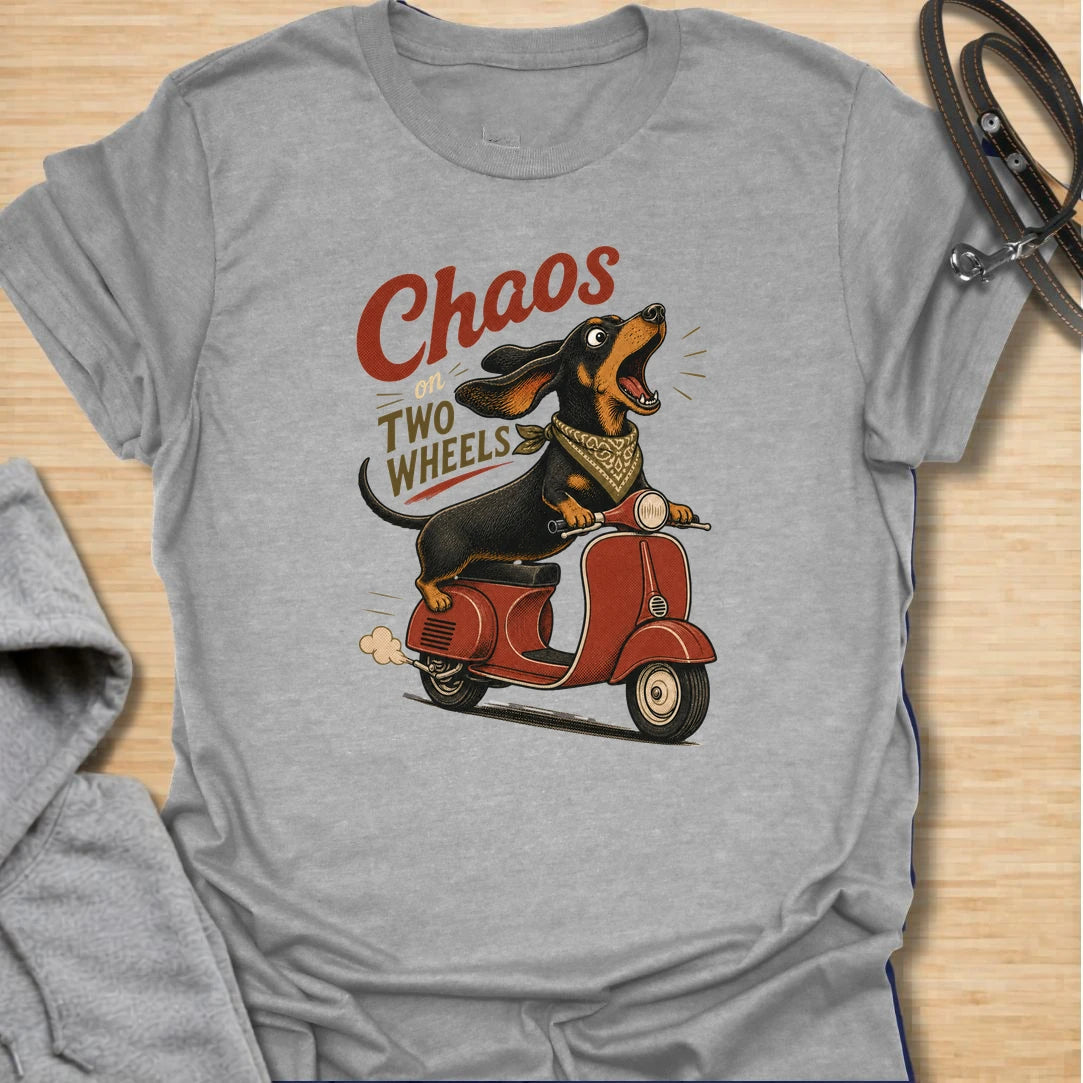 Chaos on two wheels dachshund t-shirt for anyone whose sausage dog seems to manage the household mayhem. This funny vintage-style design features a bold dachshund racing along on a scooter with retro lettering and plenty of doxie attitude. Perfect for dachshund moms, doxie dads, wiener dog lovers, and small dog owners who know chaos is part of the charm.
