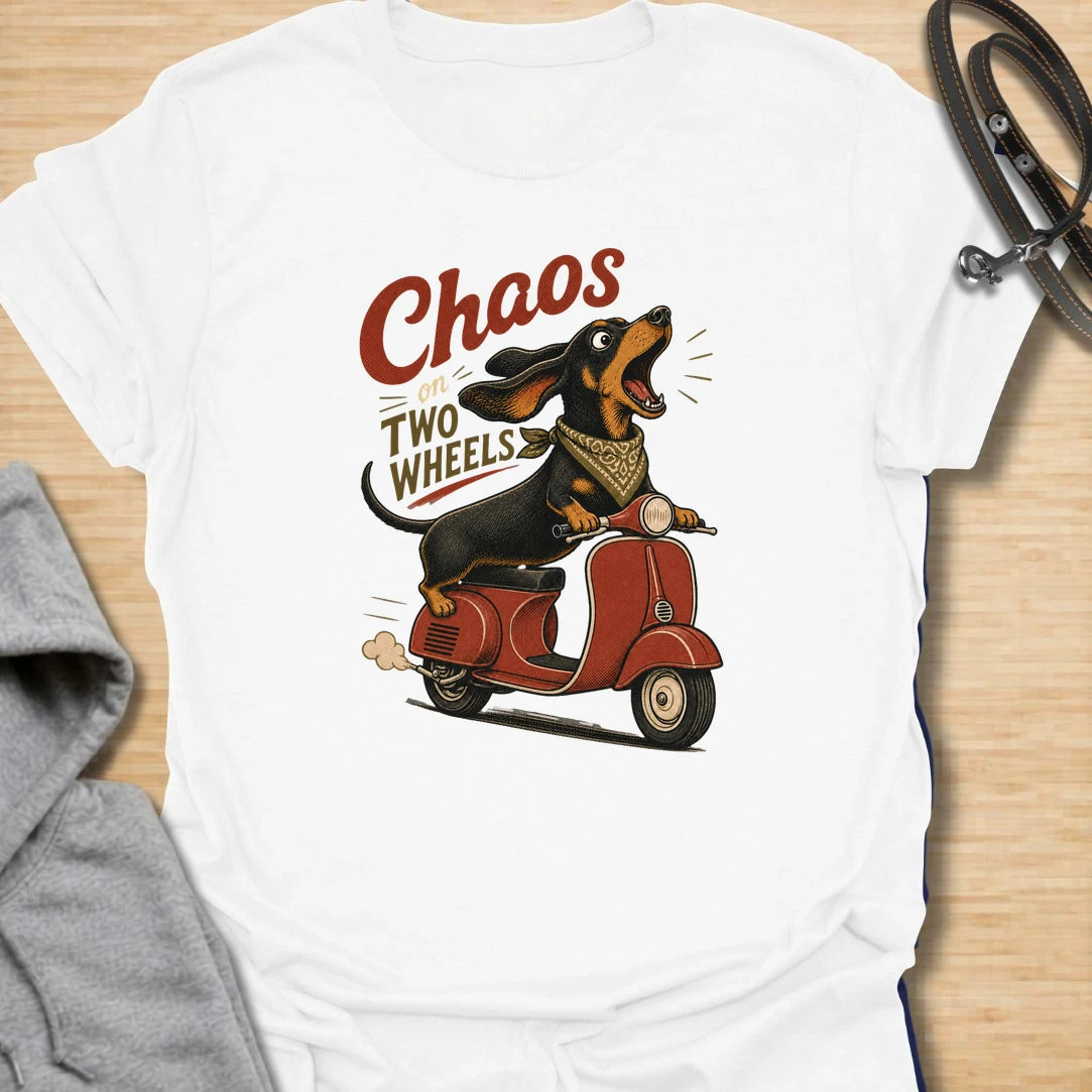 Chaos on two wheels dachshund t-shirt for anyone whose sausage dog seems to manage the household mayhem. This funny vintage-style design features a bold dachshund racing along on a scooter with retro lettering and plenty of doxie attitude. Perfect for dachshund moms, doxie dads, wiener dog lovers, and small dog owners who know chaos is part of the charm.